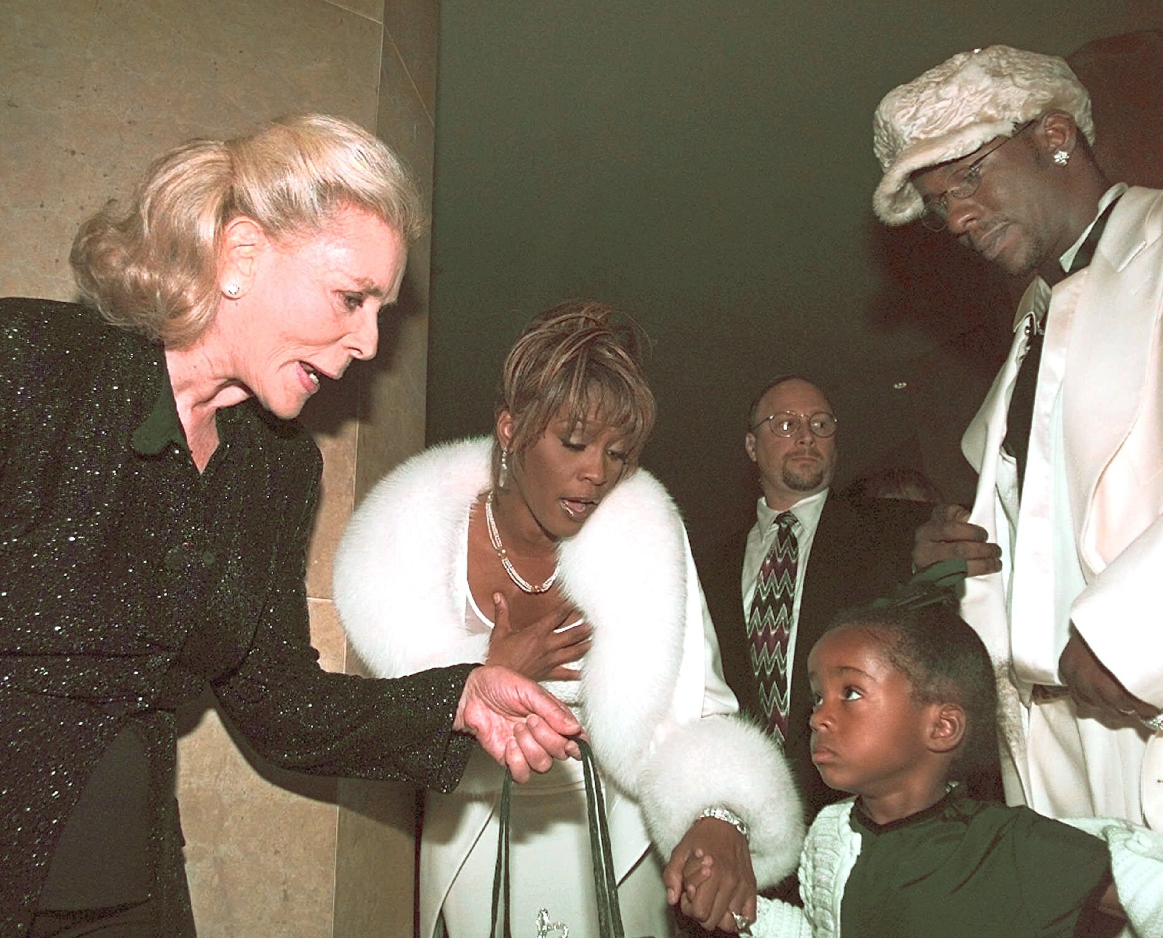 Actress Lauren Bacall, left, greets Bobbi-Christina daughter of Bobby Brown, right, and Whitney Houston during the 4th Annual International Achievement In Arts Awards in Beverly Hills, Calif., Sunday, Oct. 11, 1998. The award show was to benefit the Whitney Houston For Children, Inc. and the Starkey Hearing Foundation. (AP Photo/Michael Caulfield)