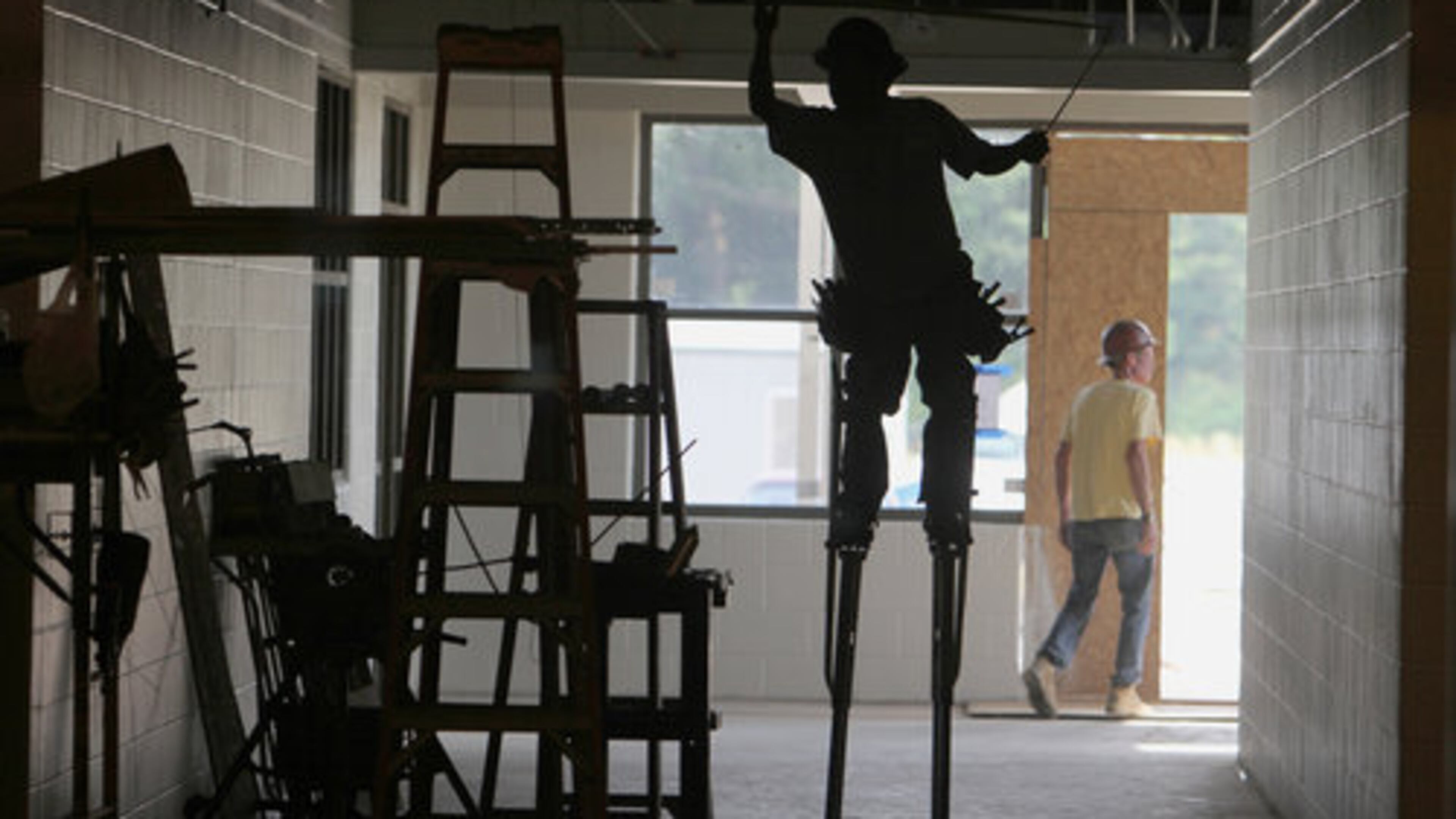 SCHOOL WORK--Evergreen construction and sub-contractor crews work on the ceiling, windows, painting and electrical inside the new elementary school that is scheduled to be completed in the fall. The new building will have 77 classrooms on about 38 acres of land. Cherokee County schools are moving forward with an ELOST vote in November. We take a look at this new elementary school in construction along Hunt Road in Acworth Wednesday, May 25, 2011.