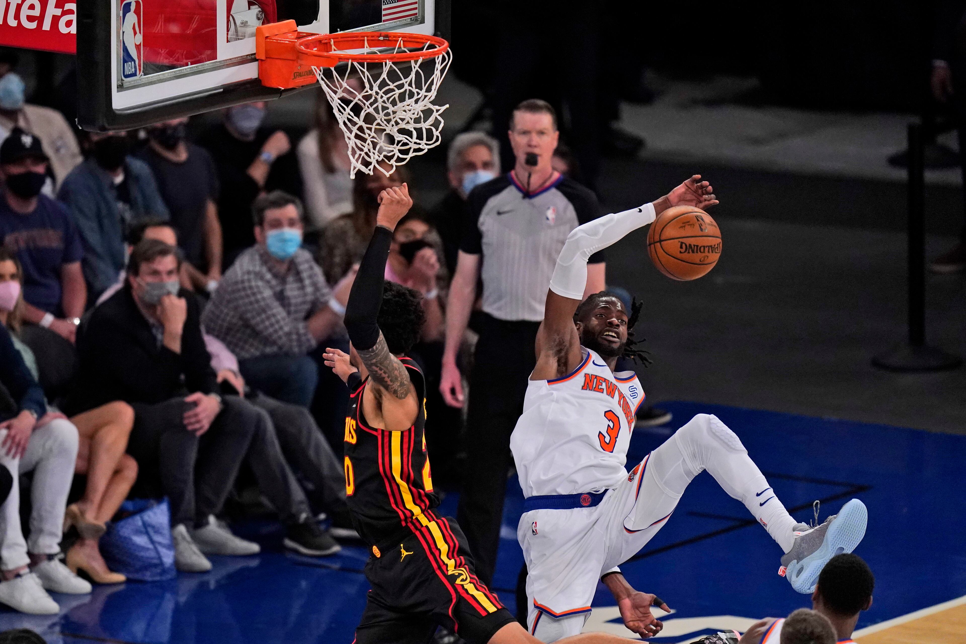 New York Knicks' Nerlens Noel (right) blocks a shot by Atlanta Hawks' John Collins (left) during the first half of Game 1 of first-round playoff series, Sunday, May 23, 2021, in New York. (Seth Wenig/AP)