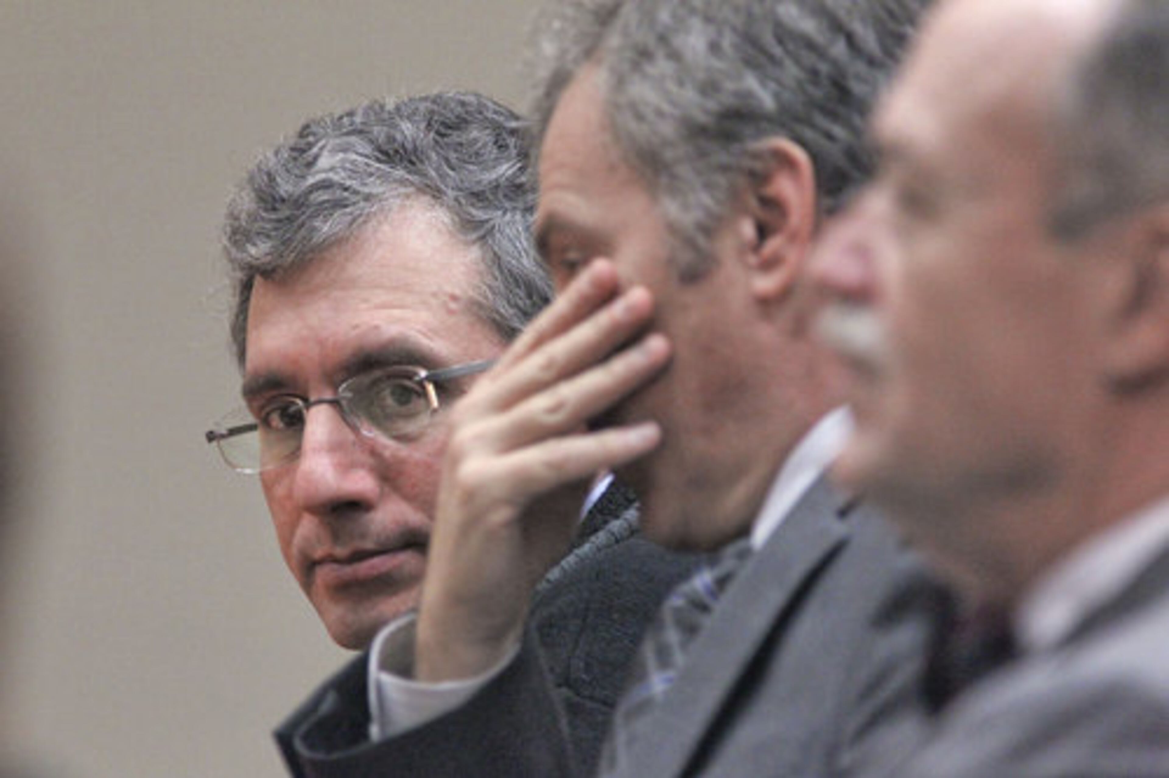 Left to right - Defendant, Hemy Neuman, defense lawyers, Bob Rubin and Doug Peters listen for the jury's instructions as they returned to the courtroom Wednesday for deliberation.