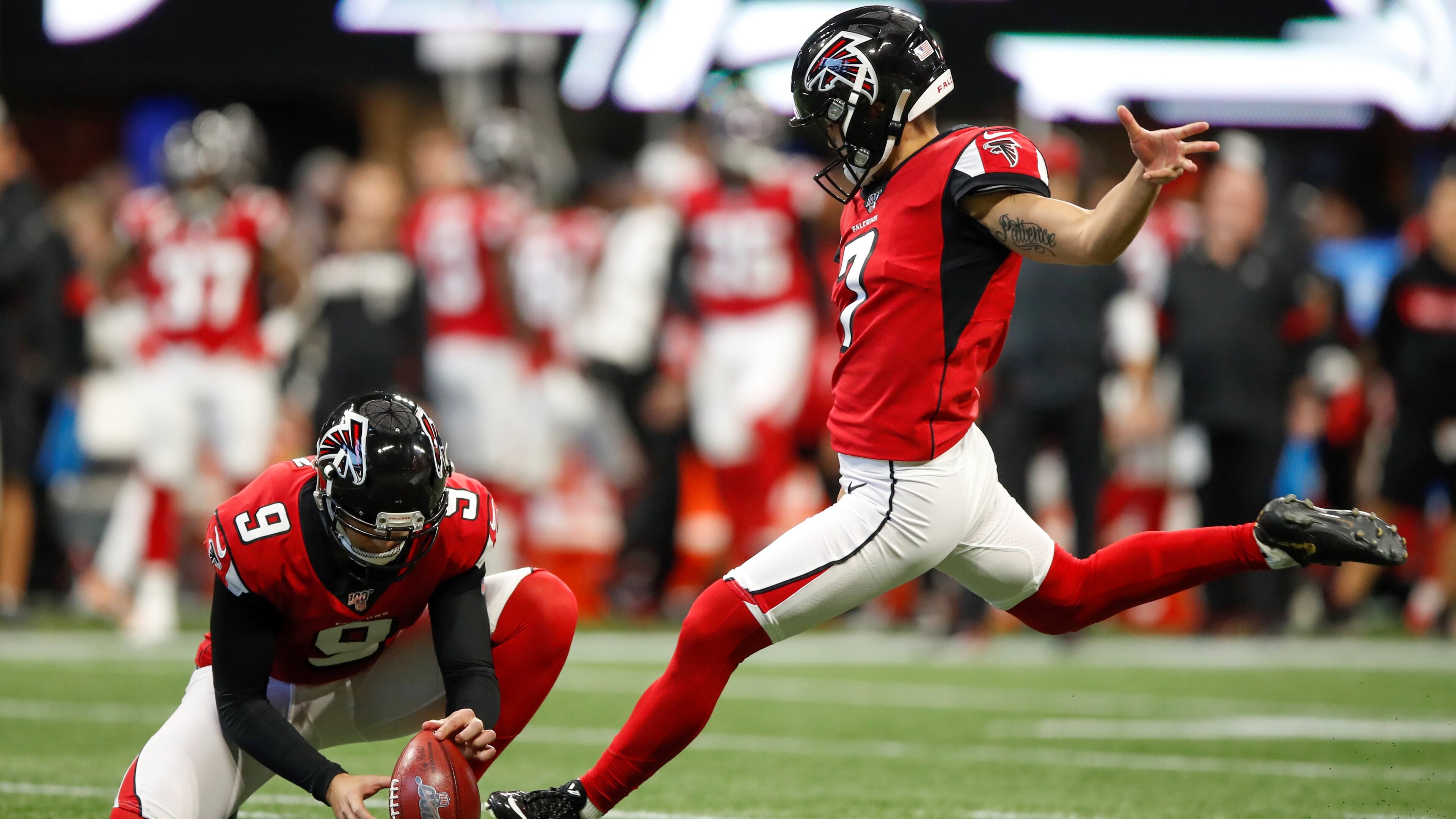 Younghoe Koo of the Atlanta Falcons kicks a field goal as Ryan Allen holds in the first half on an NFL game against the Carolina Panthers at Mercedes-Benz Stadium on December 8, 2019 in Atlanta, Georgia. (Photo by Todd Kirkland/Getty Images)