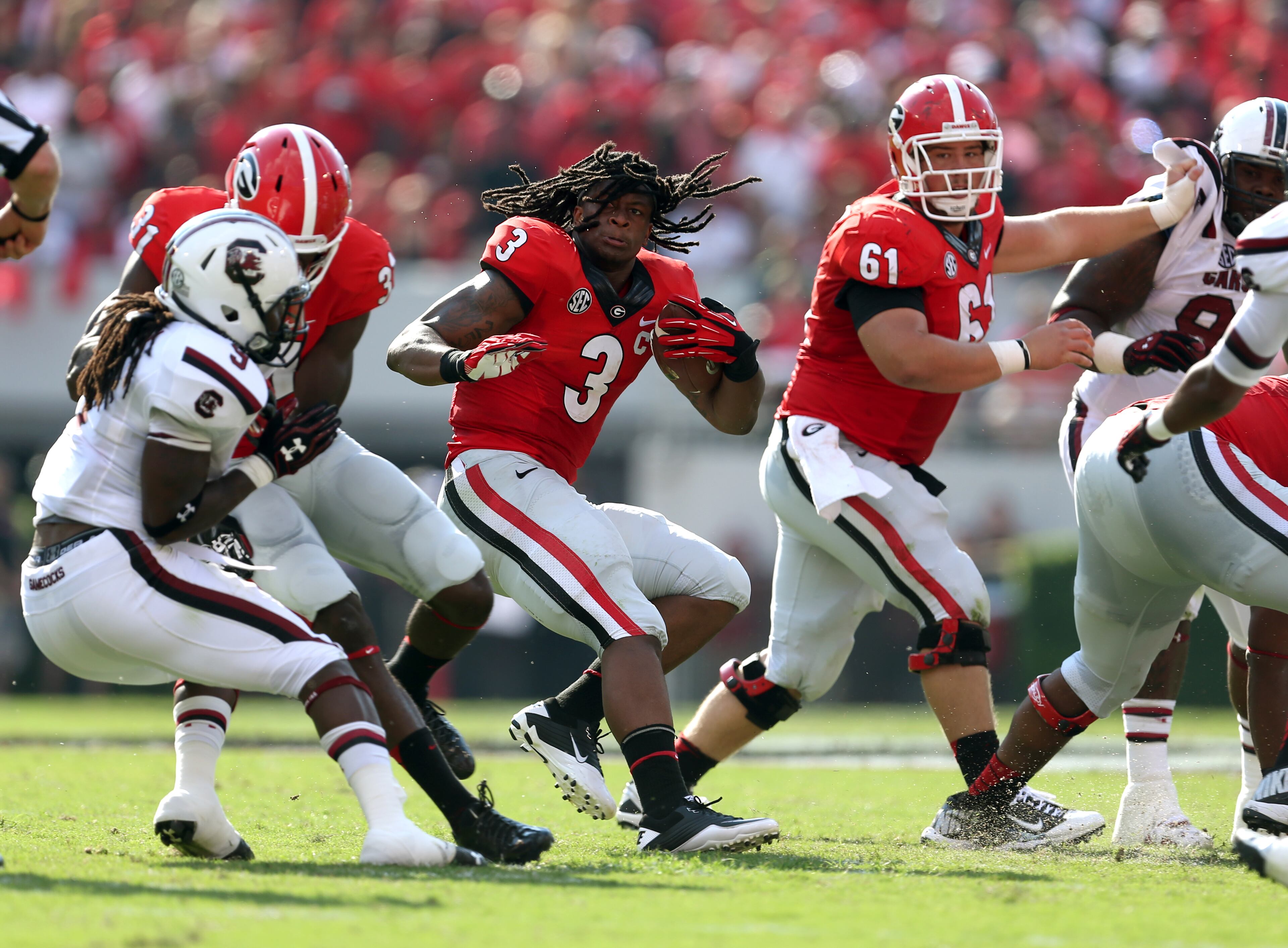 There were big wins and plays, painful losses and injuries. The AJC's Jason Getz, Curtis Compton and Johnny Crawford captured all the key moments. Take a look at our best photos from Georgia's 2013 season. Georgia tailback Todd Gurley (3) spins out of a tackle but loses his helmet during a run in the first half of their game against the University of South Carolina at Sanford Stadium Saturday afternoon in Athens, Ga., September 7, 2013. A South Carolina defender was ruled on a face mask penalty on the play and the play was stopped. No. 11 Georgia hosts No. 6 South Carolina. JASON GETZ / JGETZ@AJC.COM /p?