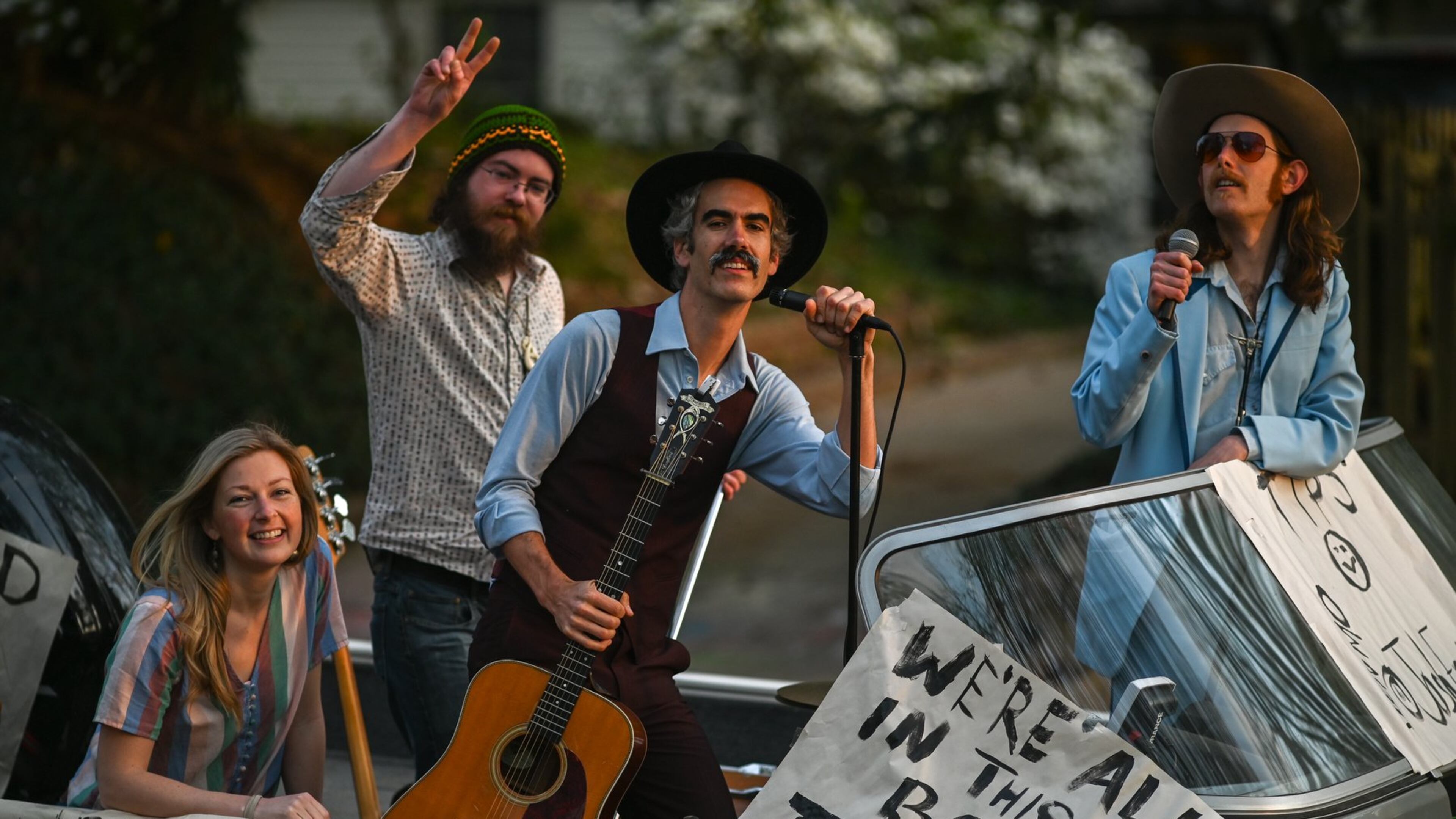 Taking it to the streets through Ormewood Park, are members of the Mermaid Motor Lounge band (Left to right: Jenna Mobley, Troy Harris (flashing the peace sign), Josh Erwin and Matt Pendrick. (Photo credit: Brian Thorpe)