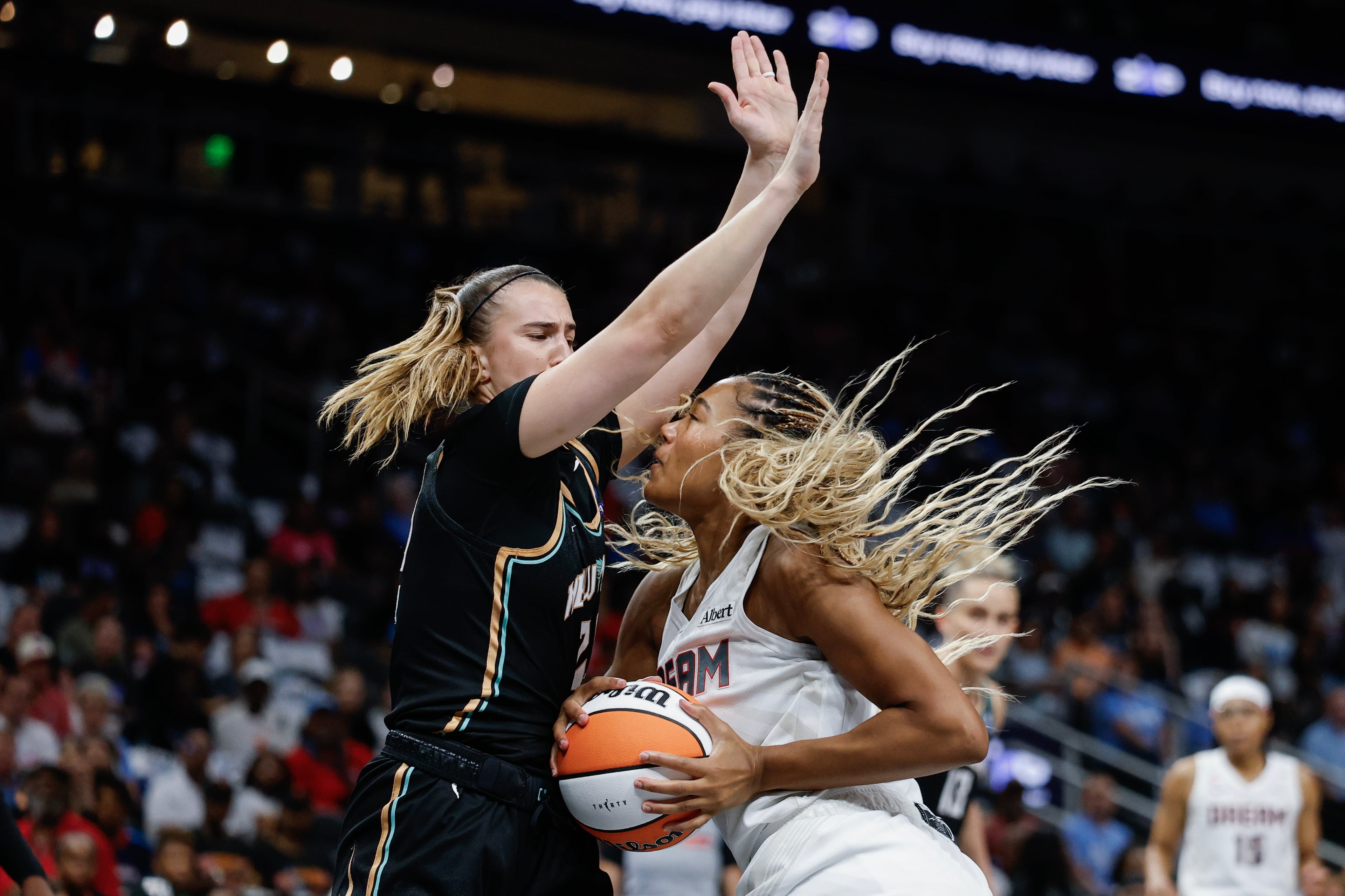 Atlanta Dream forward Naz Hillmon, right, drives against New York Liberty guard Sabrina Ionescu (20) during the first half of a WNBA semifinal playoff game 1 between the Atlanta Dream and the New York Liberty, Sunday, Oct. 4, 2026, in Atlanta. (Erik S. Lesser for the AJC)