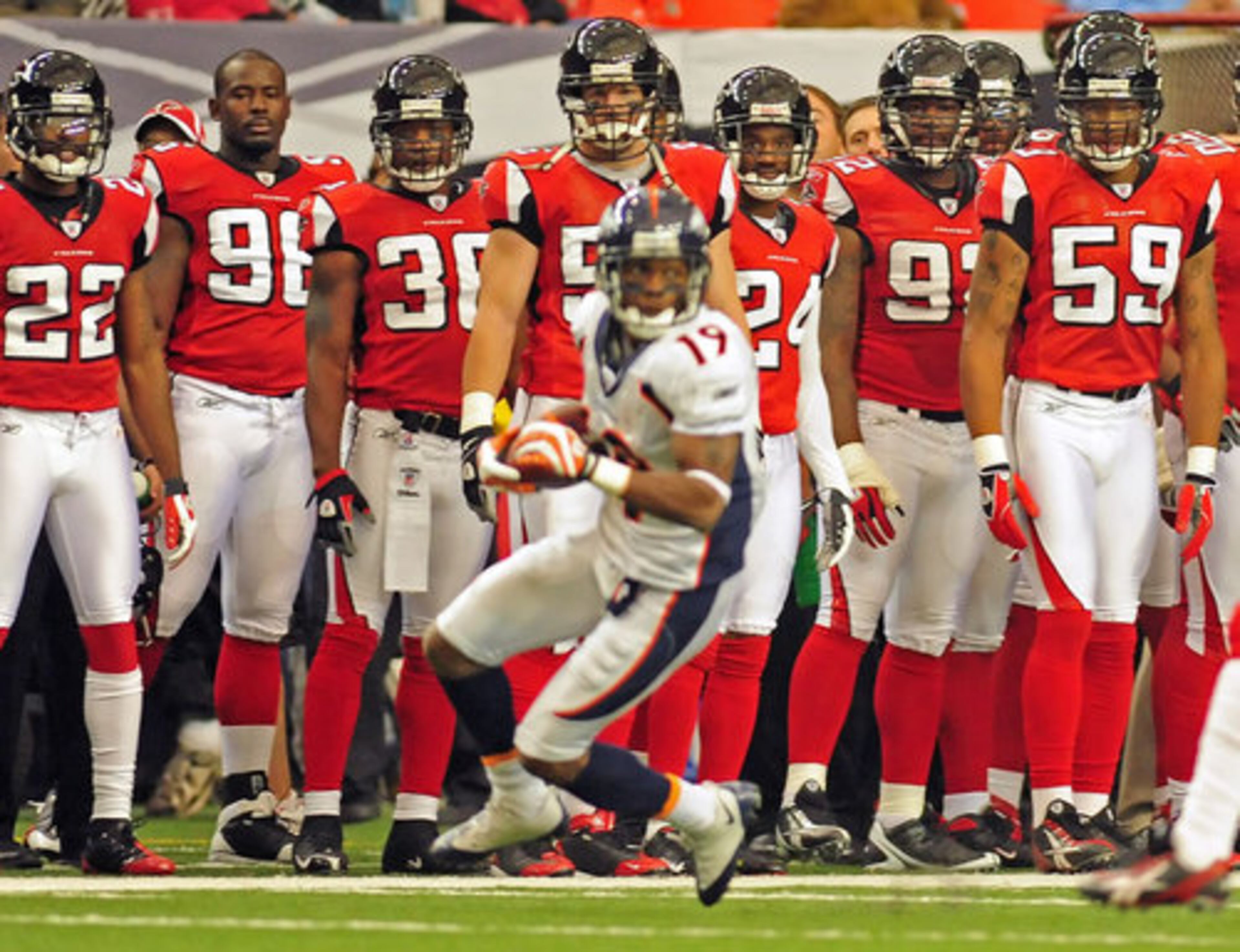 Broncos wide receiver Eddie Royal (19) has the attention of the Falcons on the sidelines. Royal had 159 return yards on five attempts against the Falcons.