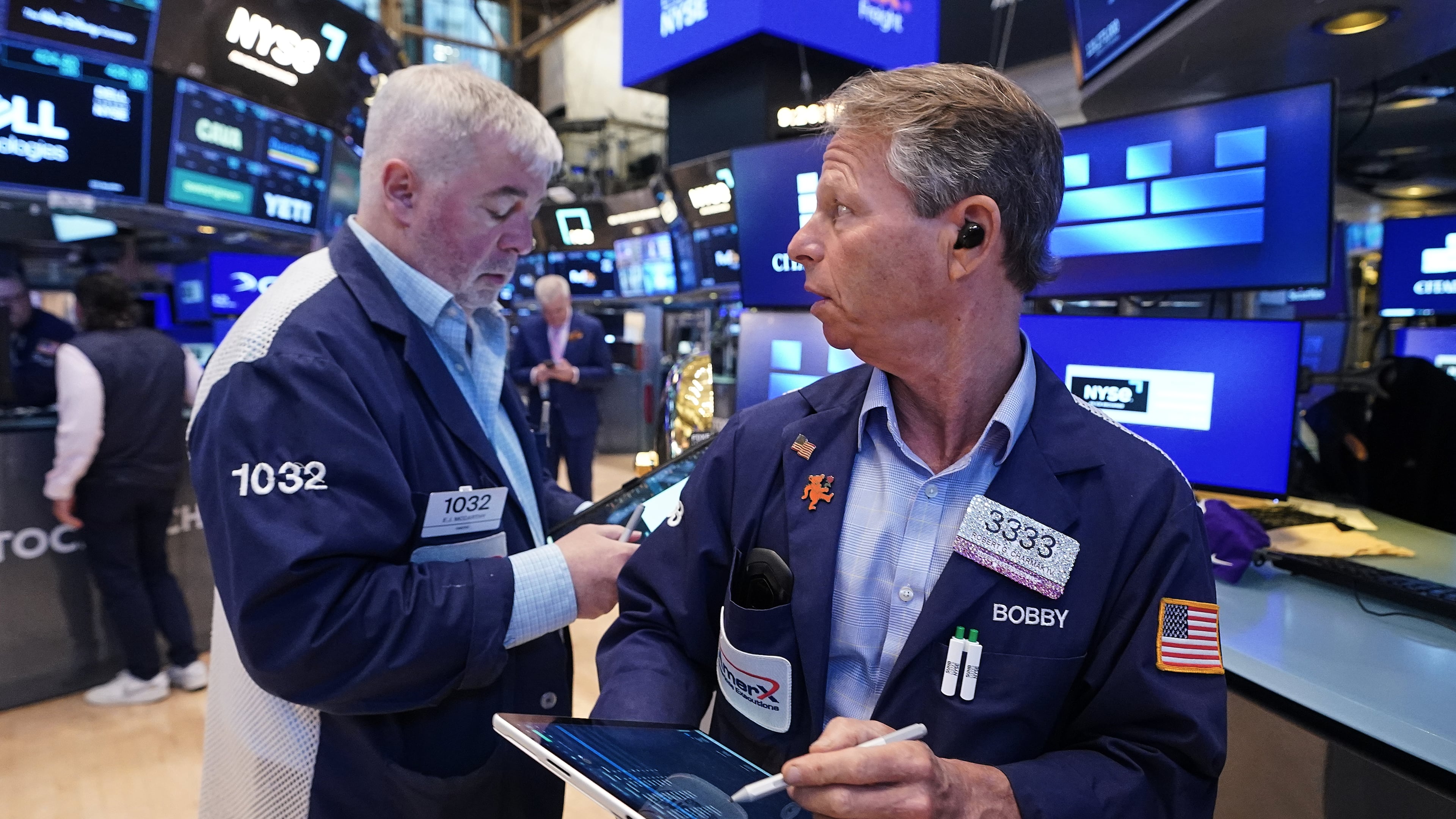 Traders Edward McCarthy, left, and Robert Charmak work on the floor of the New York Stock Exchange, Monday, June 1, 2026. (AP Photo/Richard Drew)