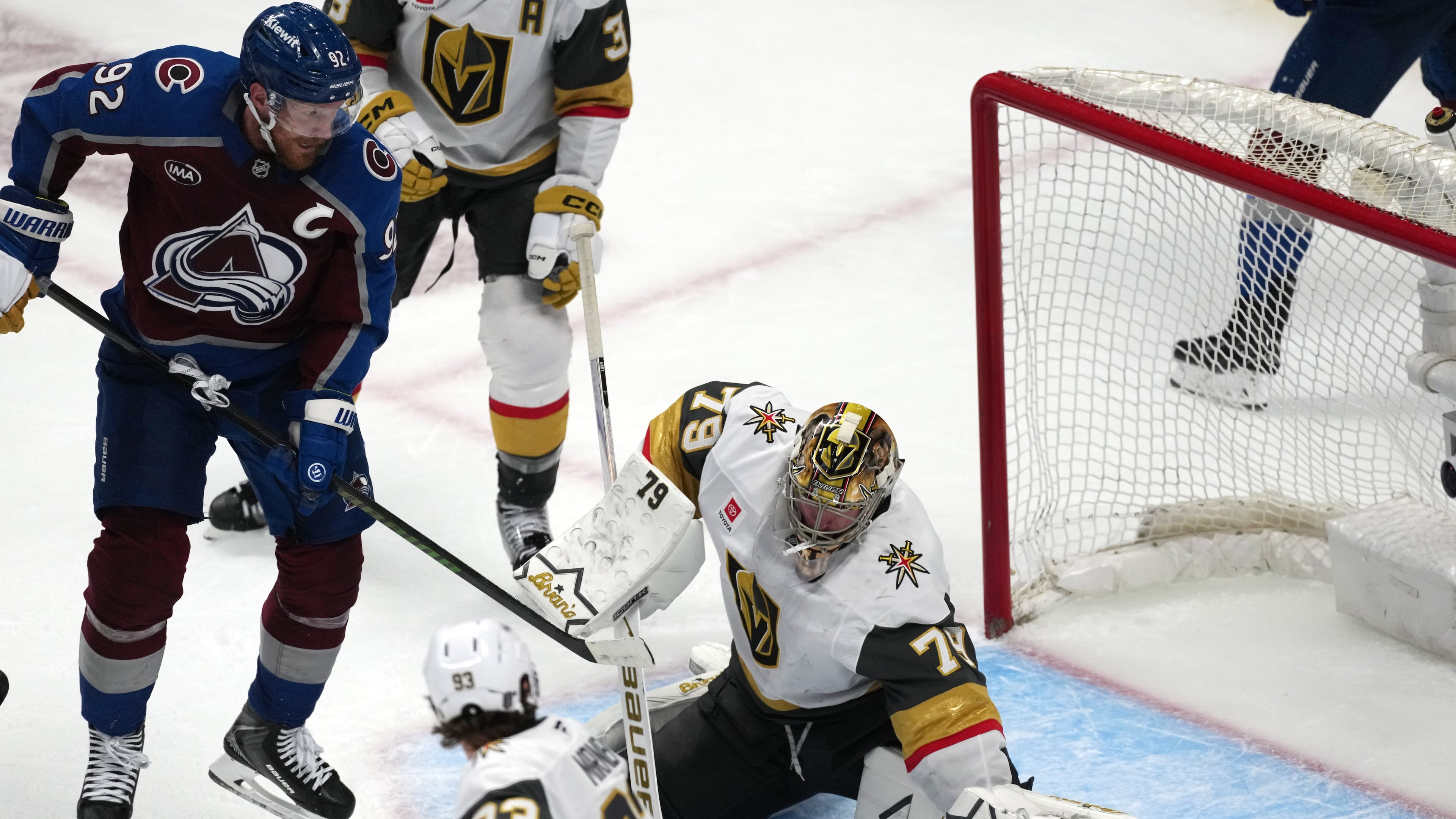 Vegas Golden Knights goaltender Carter Hart, right, stops a shot off the stick of Colorado Avalanche left wing Gabriel Landeskog during the third period in Game 1 of the Western Conference finals NHL hockey Stanley Cup playoff series Wednesday, May 20, 2026, in Denver. (AP Photo/David Zalubowski)