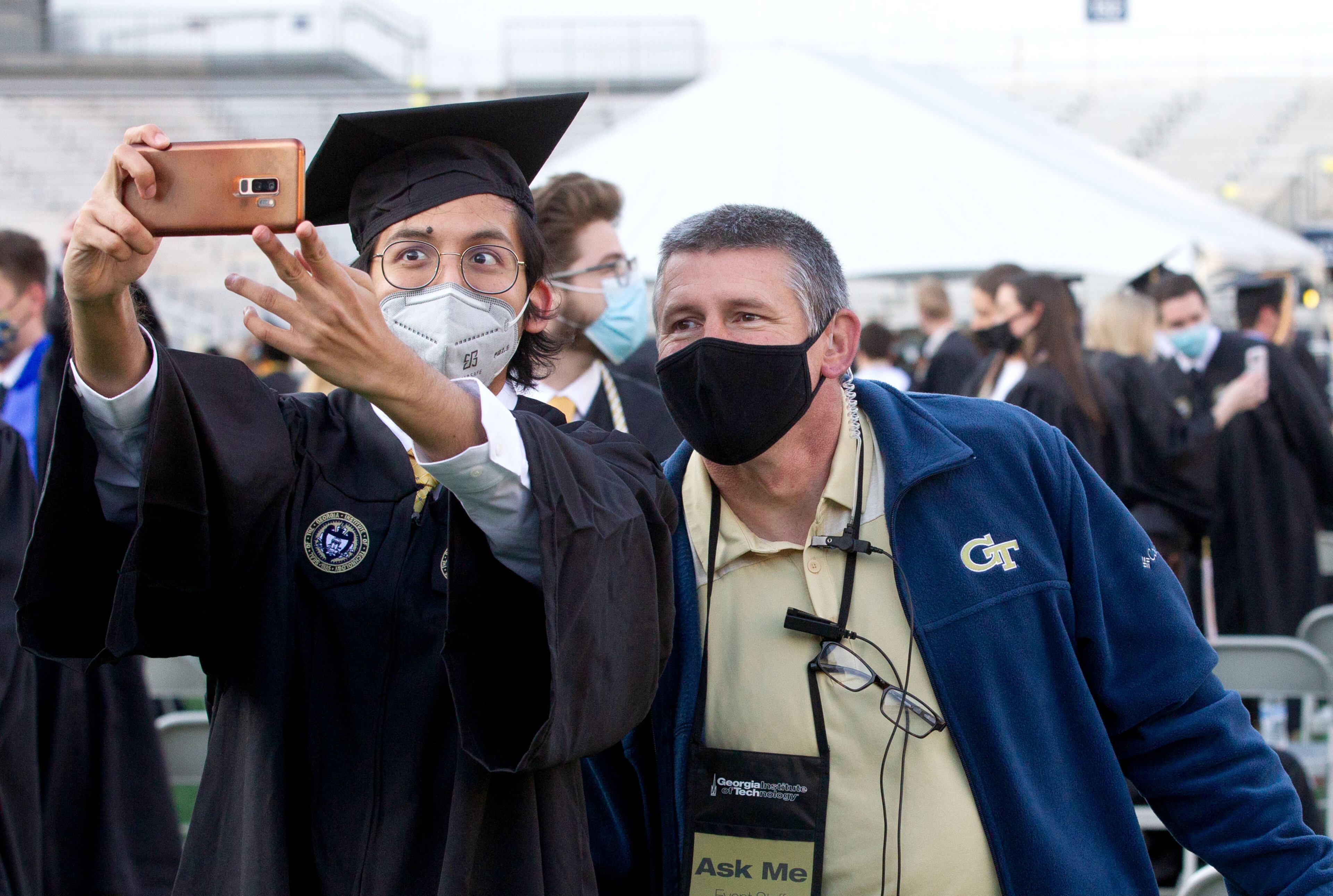 John Rat (left) takes a photograph with his adviser Jon Lowe before the start of the Georgia Tech 2021 commencement ceremony in Bobby Dodd Stadium on Saturday, May 8, 2021. (Photo: Steve Schaefer for The Atlanta Journal-Constitution)