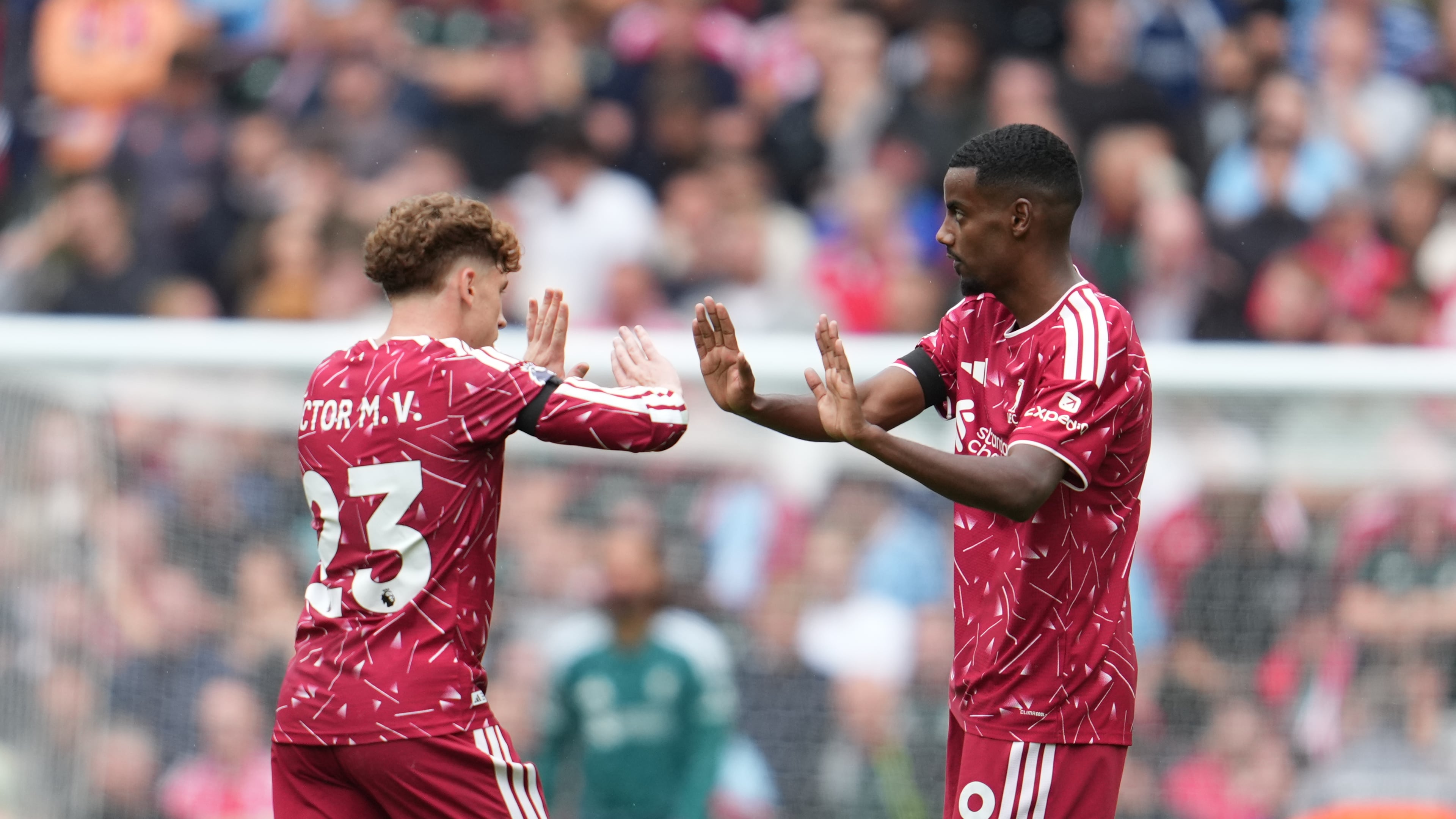 Liverpool's Alexander Isak, right, celebrates with Liverpool's Victor Munoz after scoring his side's opening goal during the English Premier League soccer match between Liverpool and Nottingham Forest in Liverpool, England, Saturday, Aug. 29, 2026. (AP Photo/Jon Super)