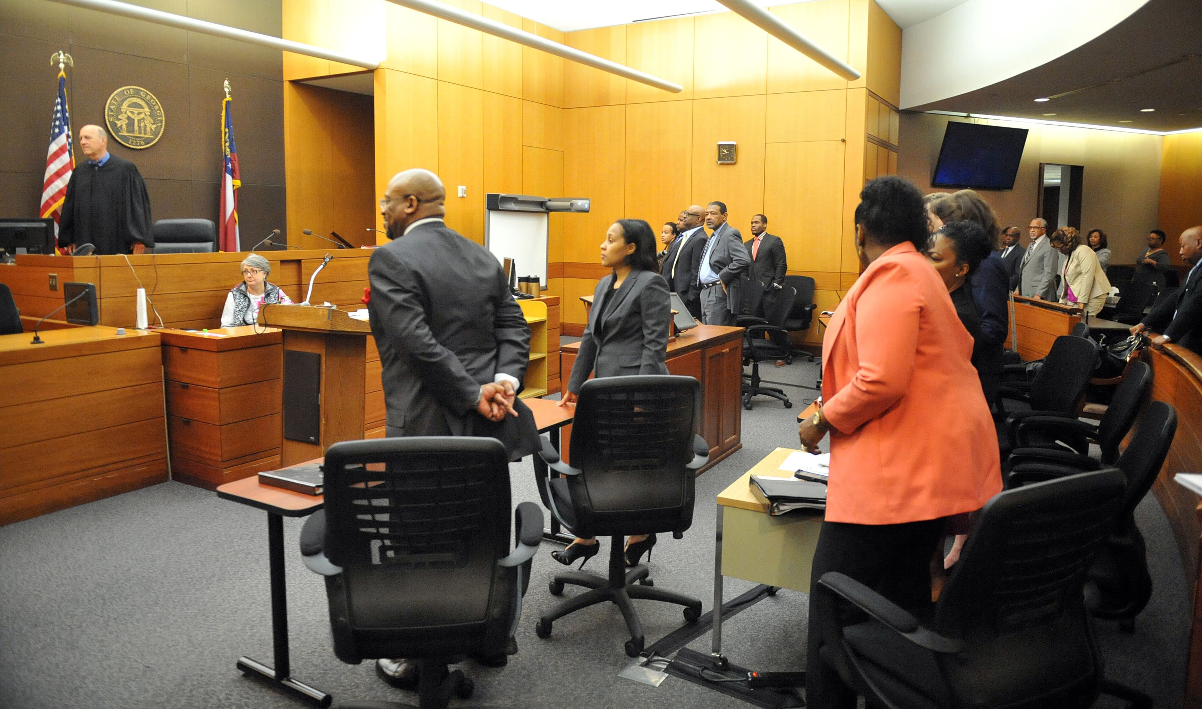 Fulton County Superior Court Judge Jerry Baxter and all others in the courtroom stand as jurors enter to hear a response to their question Wednesday in the Atlanta Public Schools test-cheating trial. (Atlanta Journal-Constitution, Kent D. Johnson, Pool)