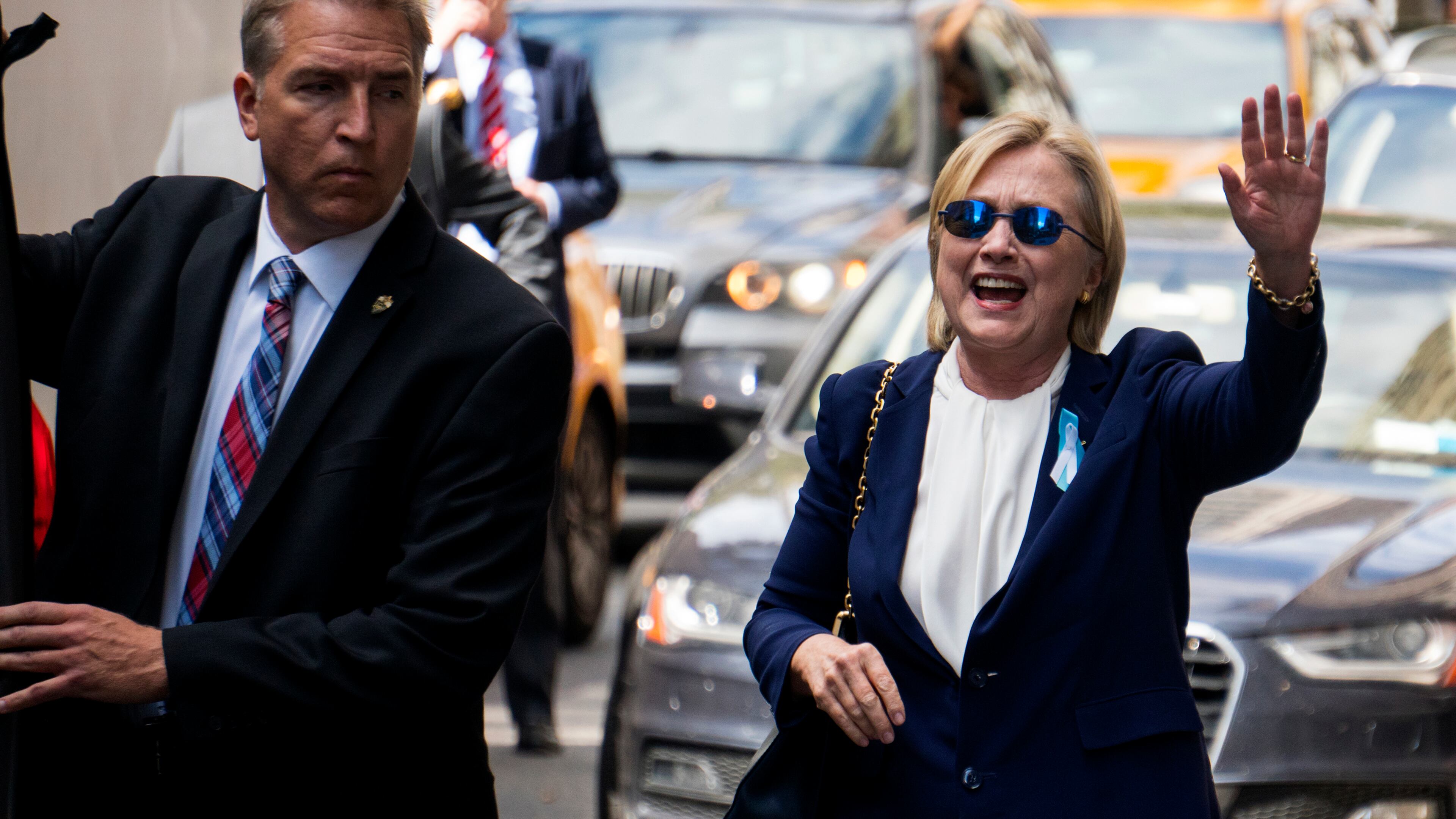 Democratic presidential candidate Hillary Clinton waves as she walks from her daughter's apartment building Sunday, Sept. 11, 2016, in New York. Clinton unexpectedly left Sunday's 9/11 anniversary ceremony in New York after feeling "overheated," according to her campaign. (AP Photo/Craig Ruttle)
