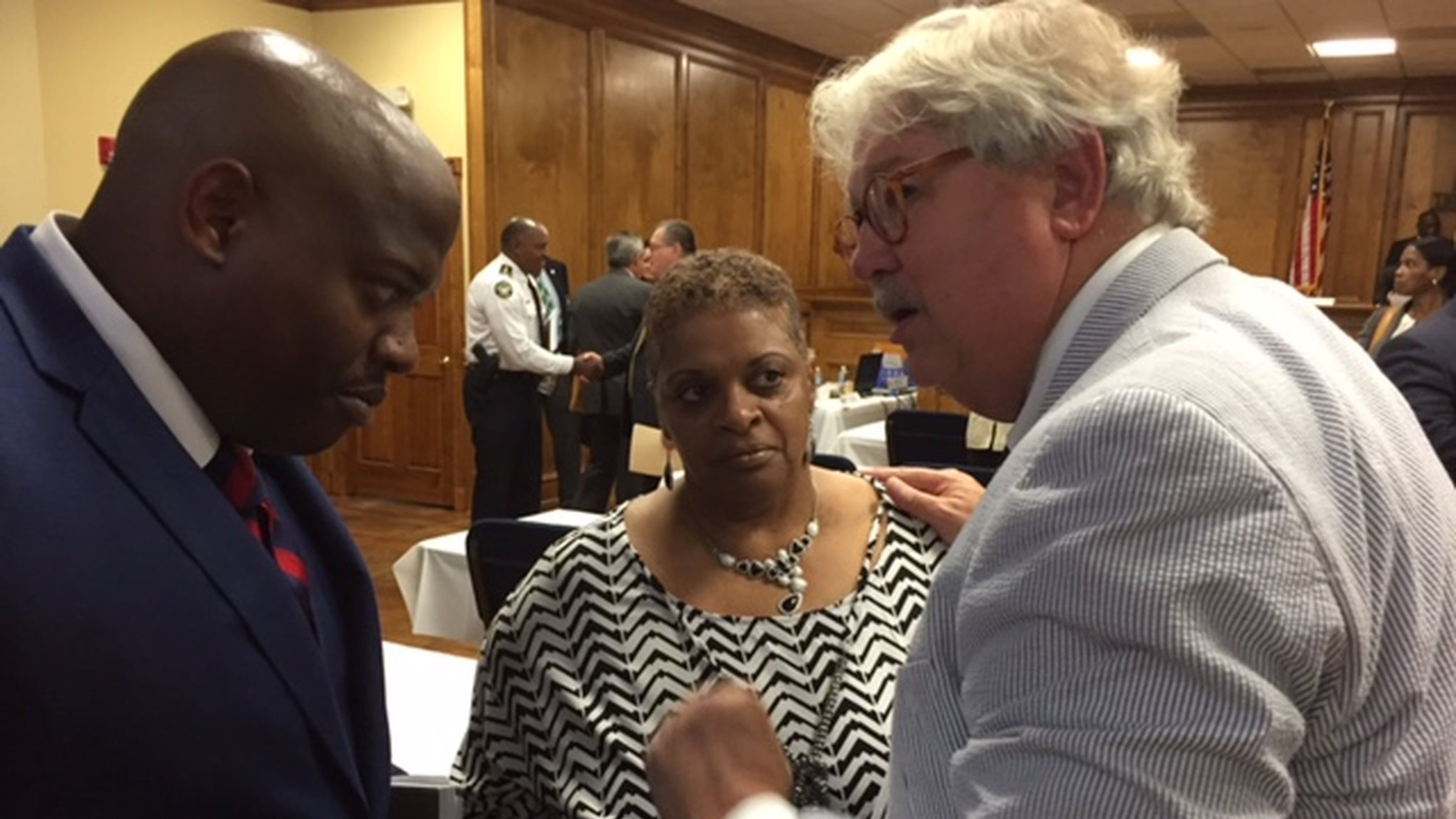Freda Waiters (center) speaks with Ken Vance (right) on Wednesday June 8 at a meeting of the Georgia Peace Officer Standards and Training Council (POST). Vance is the director of POST. The council voted on Wednesday to revoke the police certification of Luther Lewis, a former Union City Police officer who shot and killed Waiters son, Ariston, in 2011. BRAD SCHRADE / BSCHRADE@AJC.COM