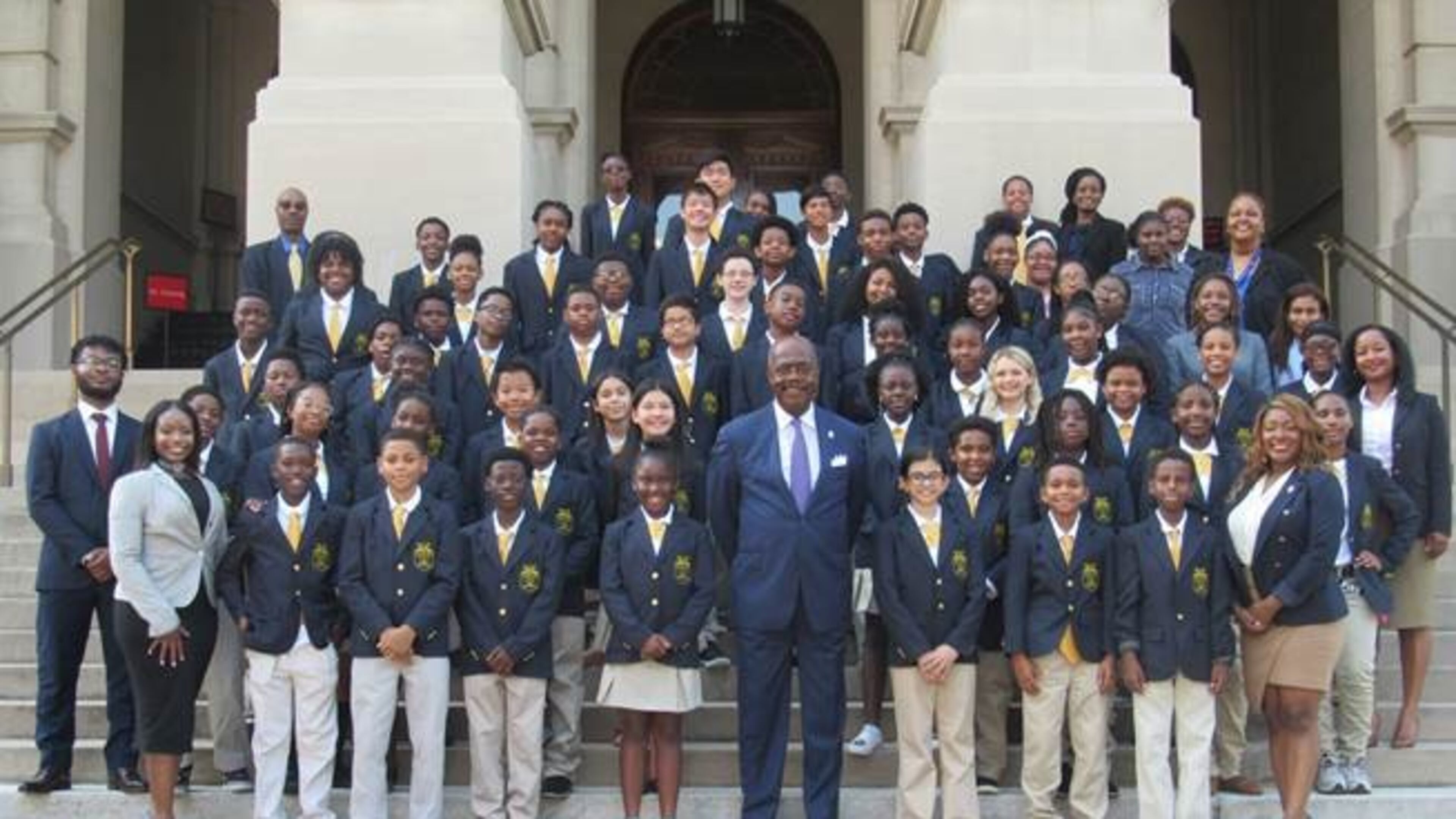 Donning their white polo shirts, khaki pants, and sharp navy blue blazers, students in the 21st year of the Fulton County District Attorney’s Office “Junior DA” program took their group photo with District Attorney Paul L. Howard, Jr. on the steps of the Georgia State Capitol, Thursday. CONTRIBUTED