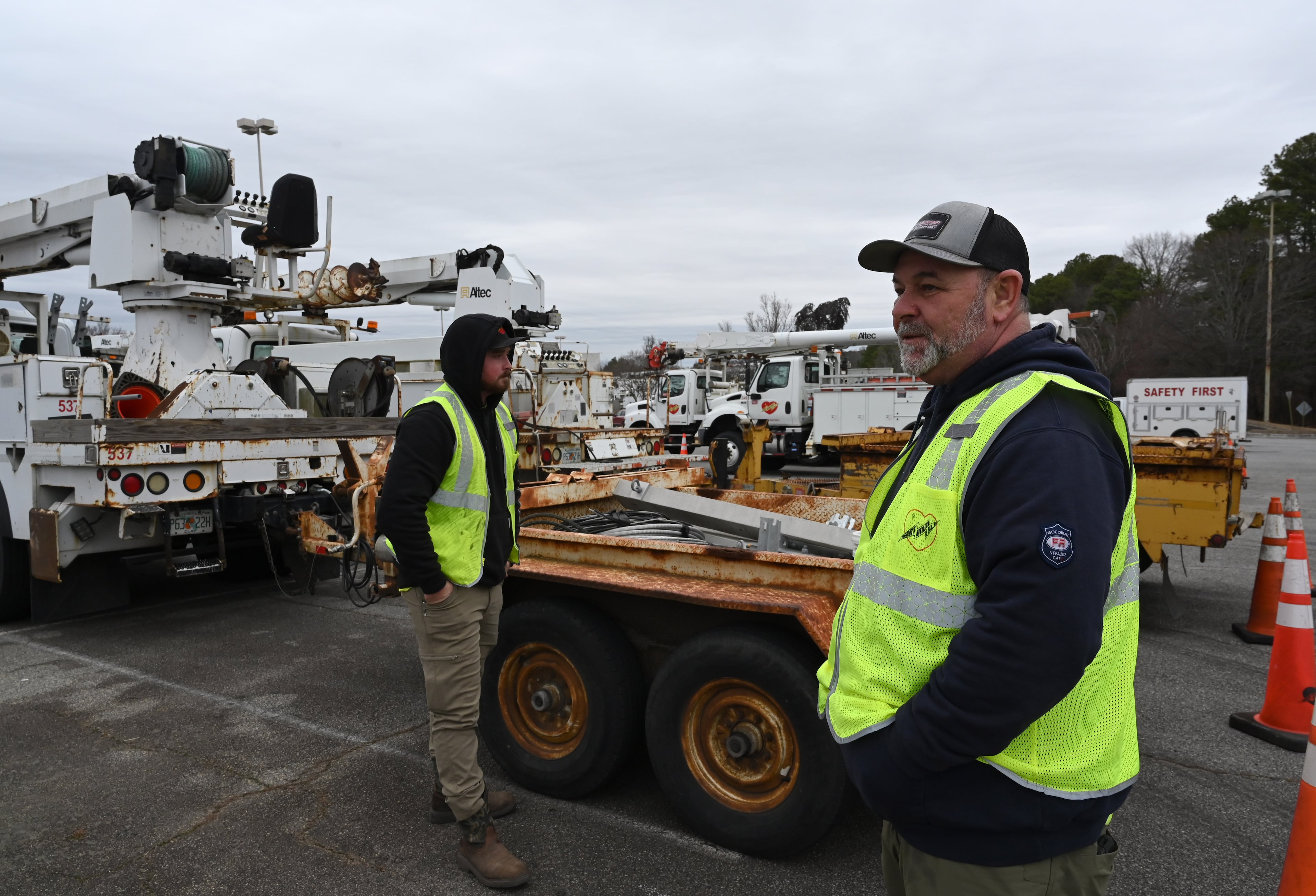 Kade Maulden (left) from Florida and Wyman Boatwright, from South Carolina, both contractors with Georgia Power, stand outside their truck at a parking lot at Northlake Mall, Saturday, Jan. 24, 2026, in Atlanta. (Hyosub Shin/AJC)