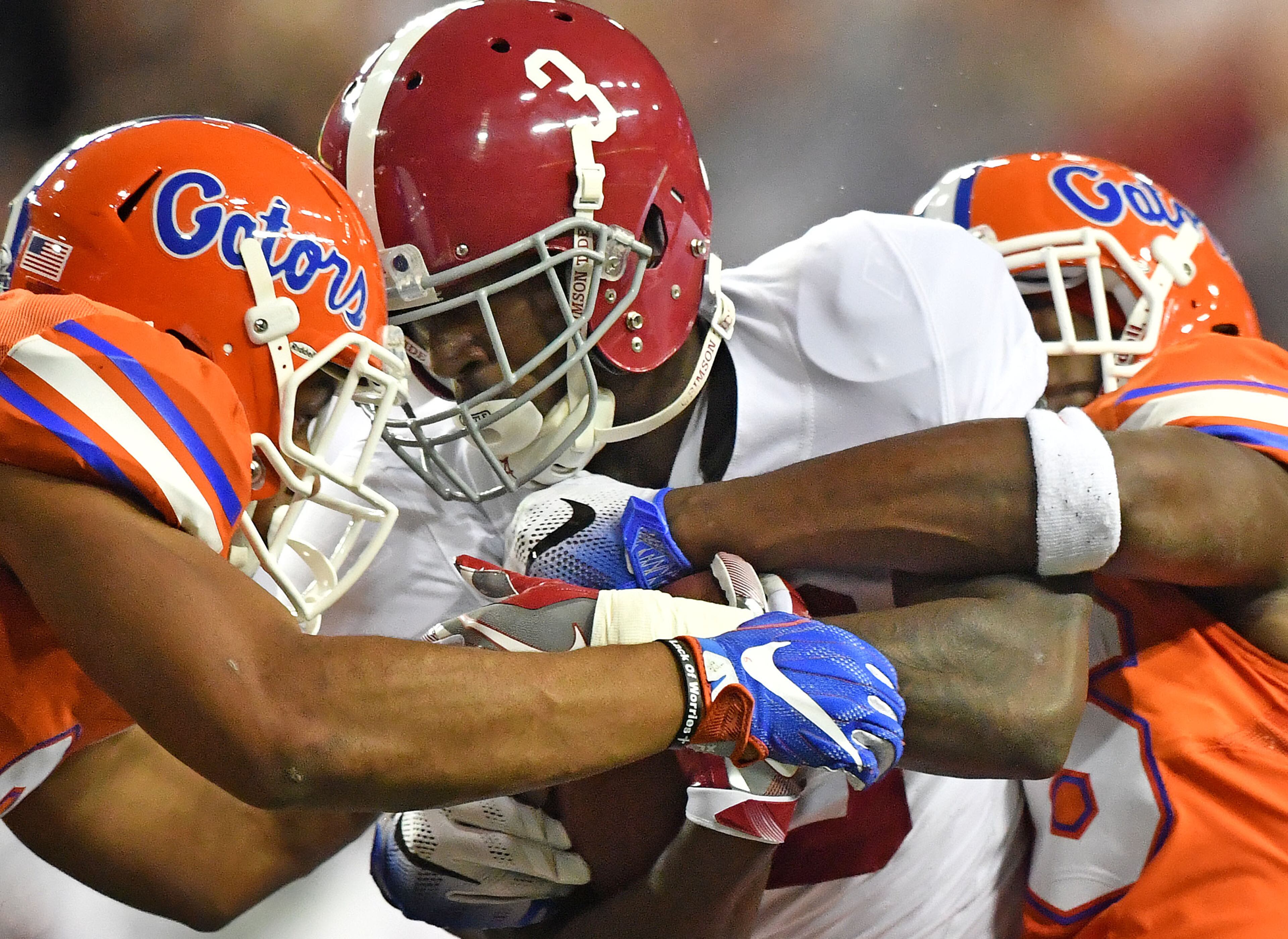 December 3, 2016 Atlanta - Alabama wide receiver Calvin Ridley (3) is stoped by Florida defensive back Quincy Wilson (left) and Florida defensive back Marcell Harris in the first half of the 2016 SEC Championship at the Georgia Dome on Saturday, December 3, 2016. HYOSUB SHIN / HSHIN@AJC.COM
