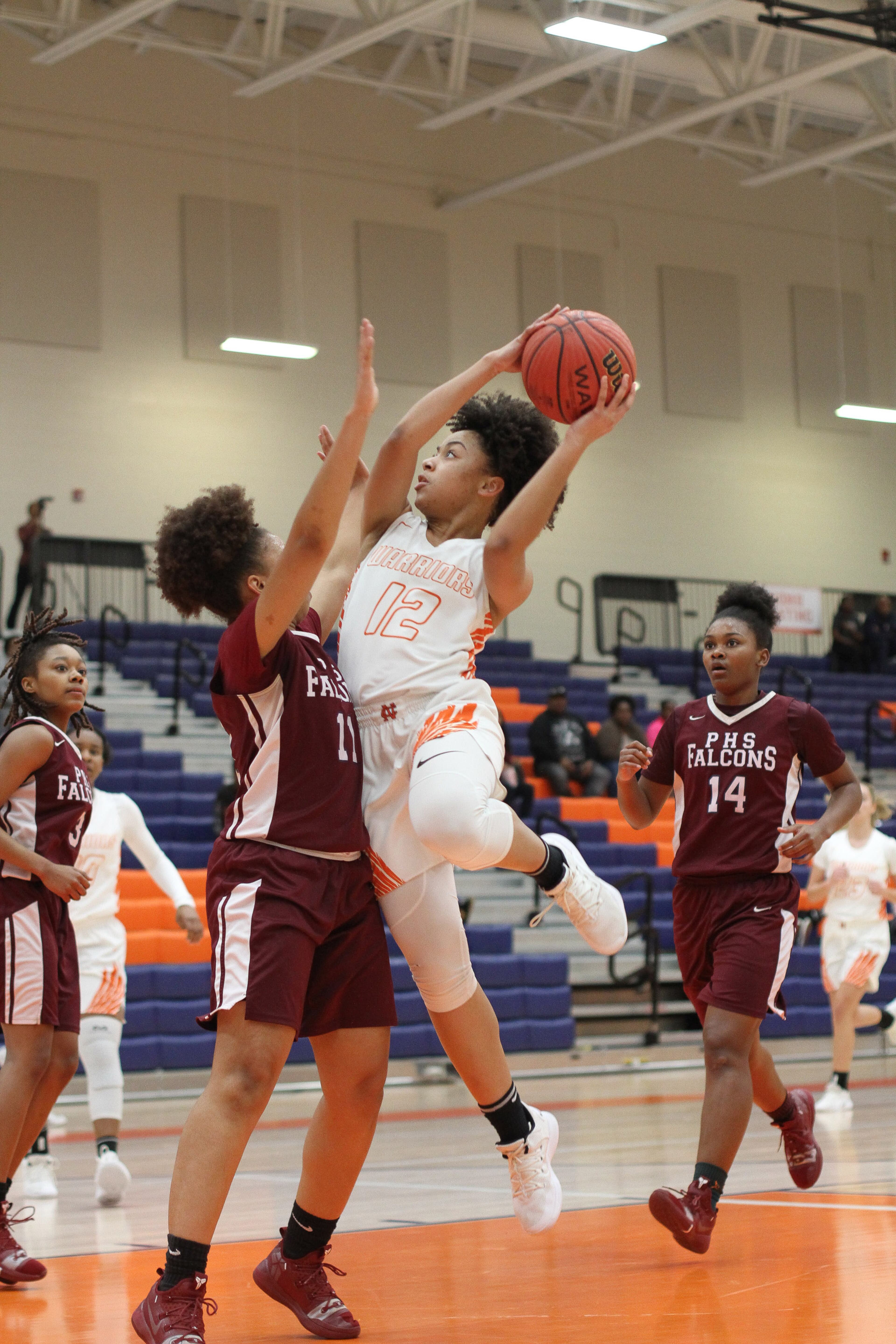 North Cobb High School girls basketball player Madison Edge drives to the basket while being guarded by Pebblebrook High School player Azaria Alexander during the first round of the girls' high school basketball tournament at North Cobb High School in Kennesaw February 15, 2018. STEVE SCHAEFER / SPECIAL TO THE AJC