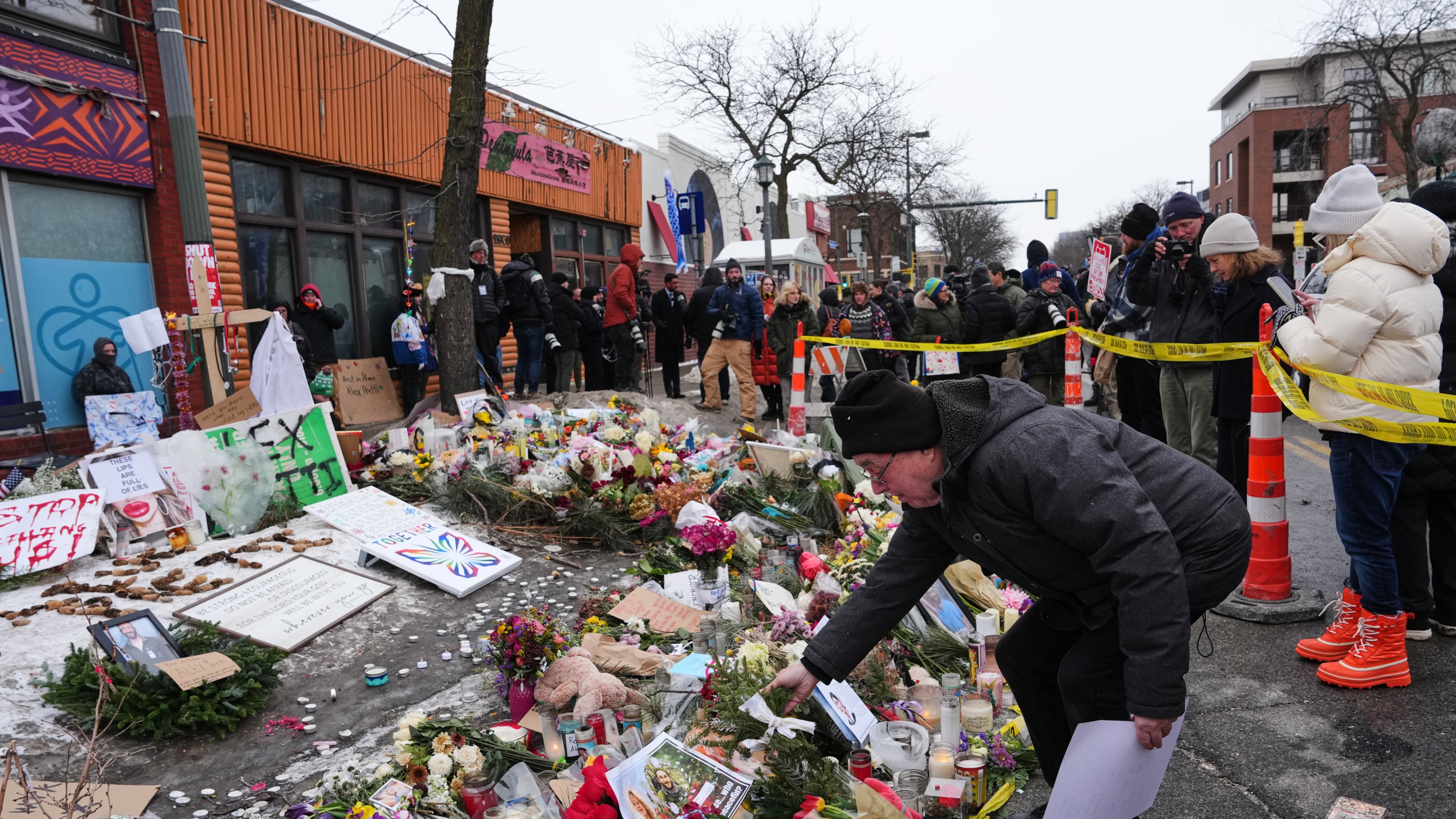 People visit a makeshift memorial for 37-year-old Alex Pretti, who was fatally shot by a U.S. Border Patrol officer over the weekend, Monday, Jan. 26, 2026, in Minneapolis. (AP Photo/Adam Gray)