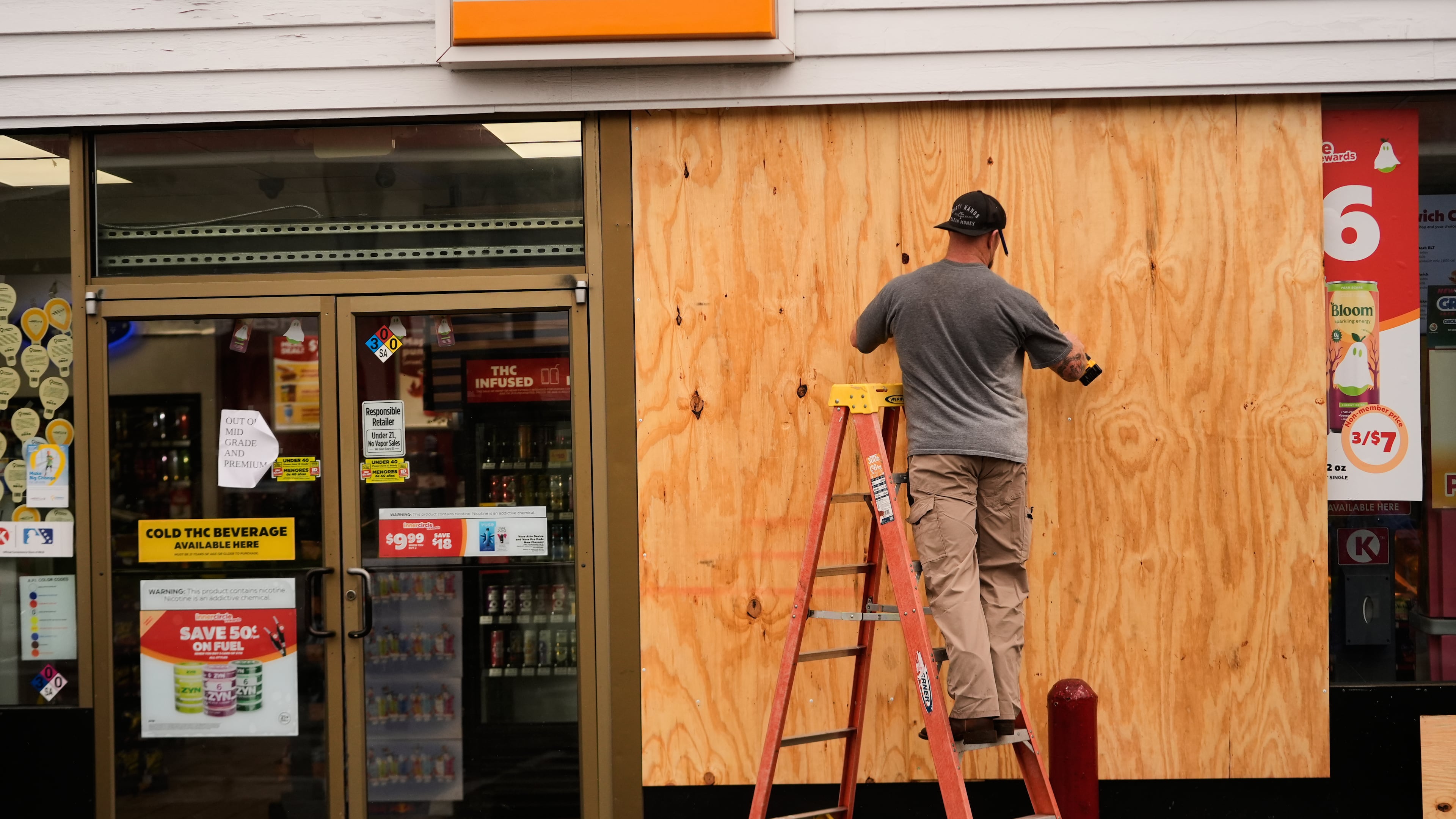 Jason Coffey boards up a convenience store at a gas station as Hurricane Isaias approaches Pensacola Beach, Fla., Friday, Oct. 9, 2026. (AP Photo/Gerald Herbert)