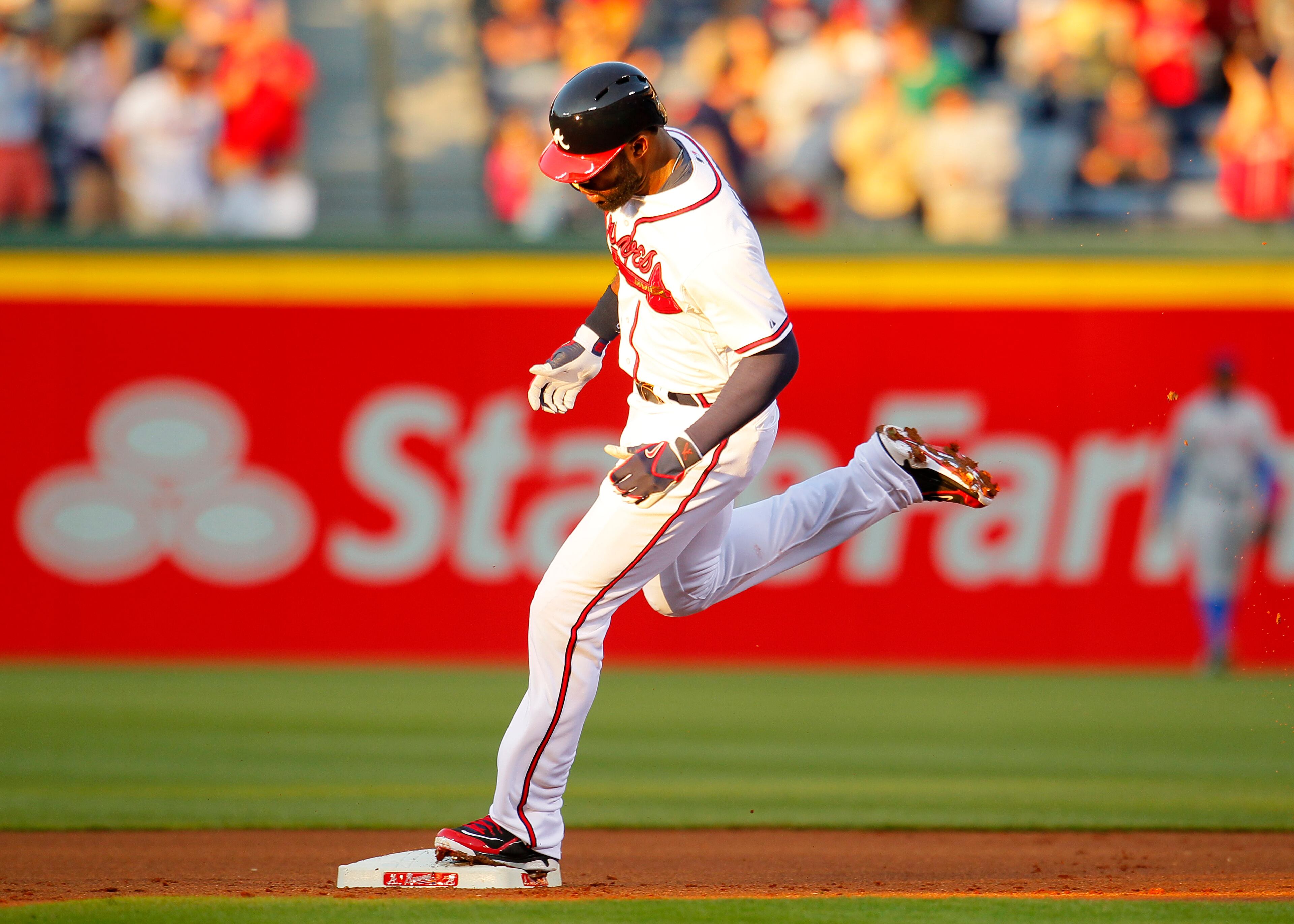 Atlanta Braves' Jason Heyward rounds second base after hitting a home run in the first inning of the baseball game against the New York Mets, Wednesday, April 9, 2014, in Atlanta. (AP Photo/Todd Kirkland)