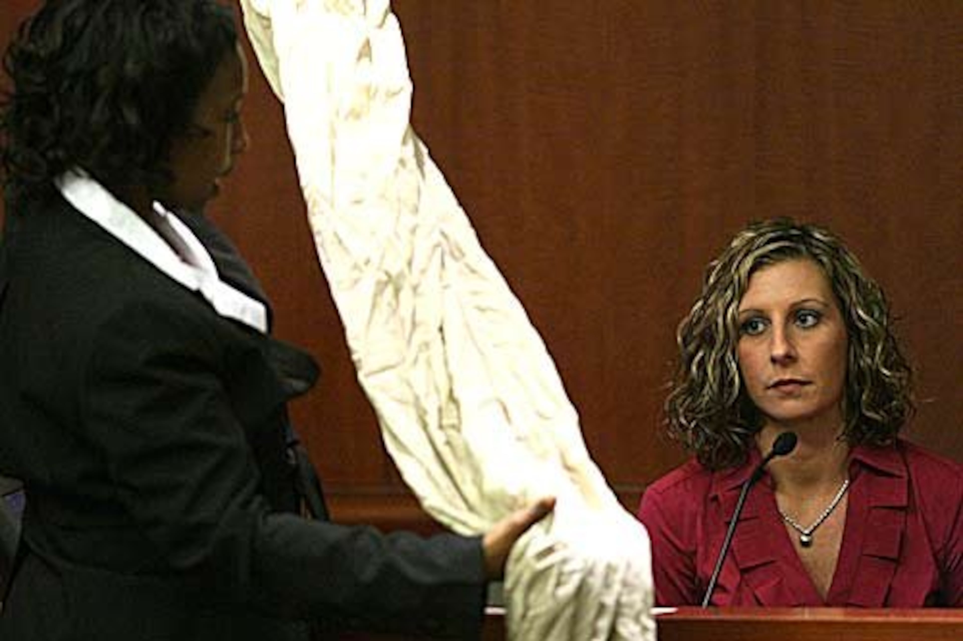 Ashley Smith looks at evidence held by prosecutor Kellie Hill.