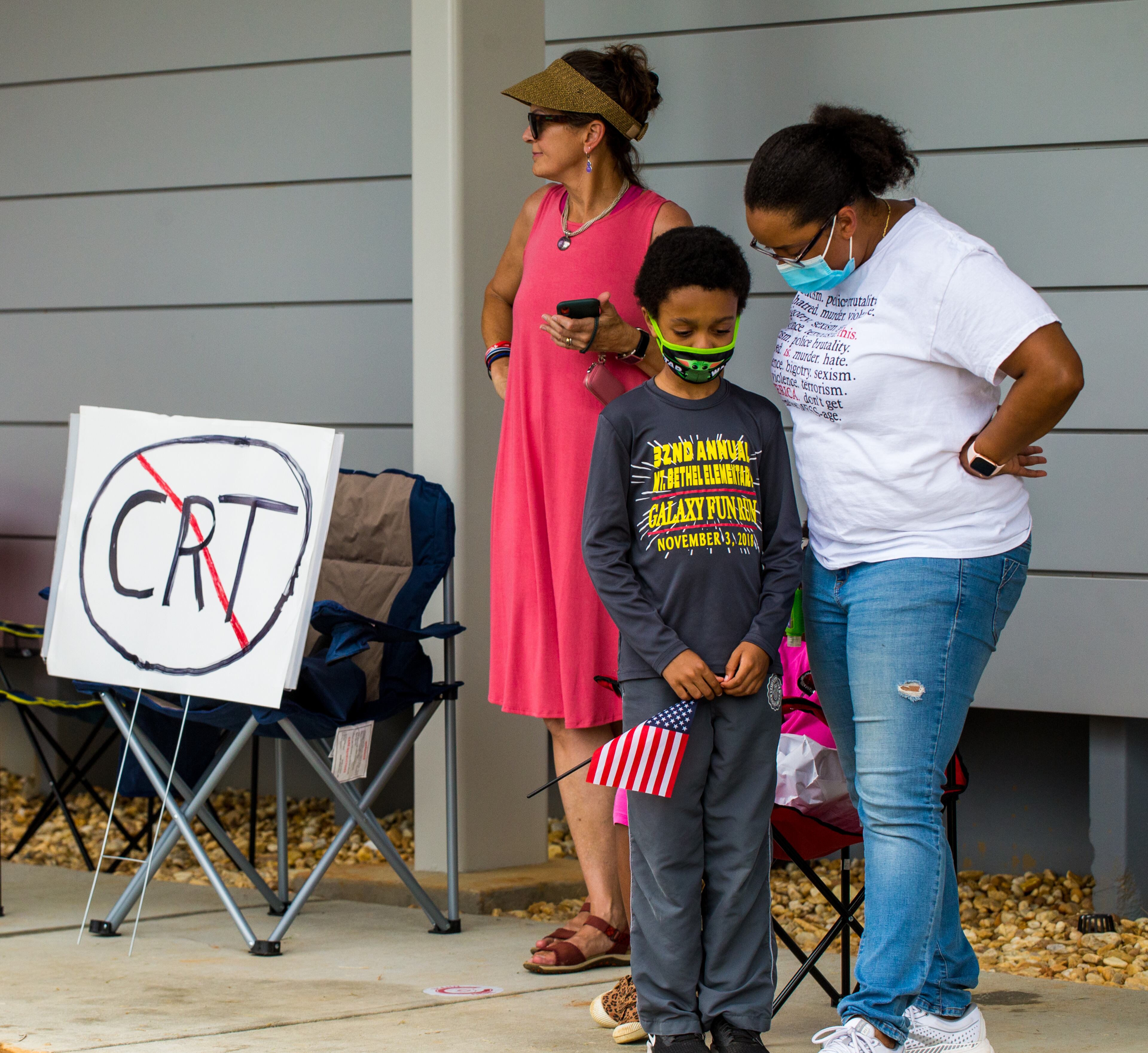 Waiting for his turn to speak, upcoming 6th grader Alex Judge III, is consoled by his mother Laura Judge, right, after he was verbally attacked by adults protesting critical race theory before a Cobb County of Education board meeting begins. Teachers, parents and local residents gather to voice their opinions on critical race theory and what Cobb County teaches and the reviews initiated by the school board Thursday, June 10, 2021. (Jenni Girtman for The Atlanta Journal Constitution)