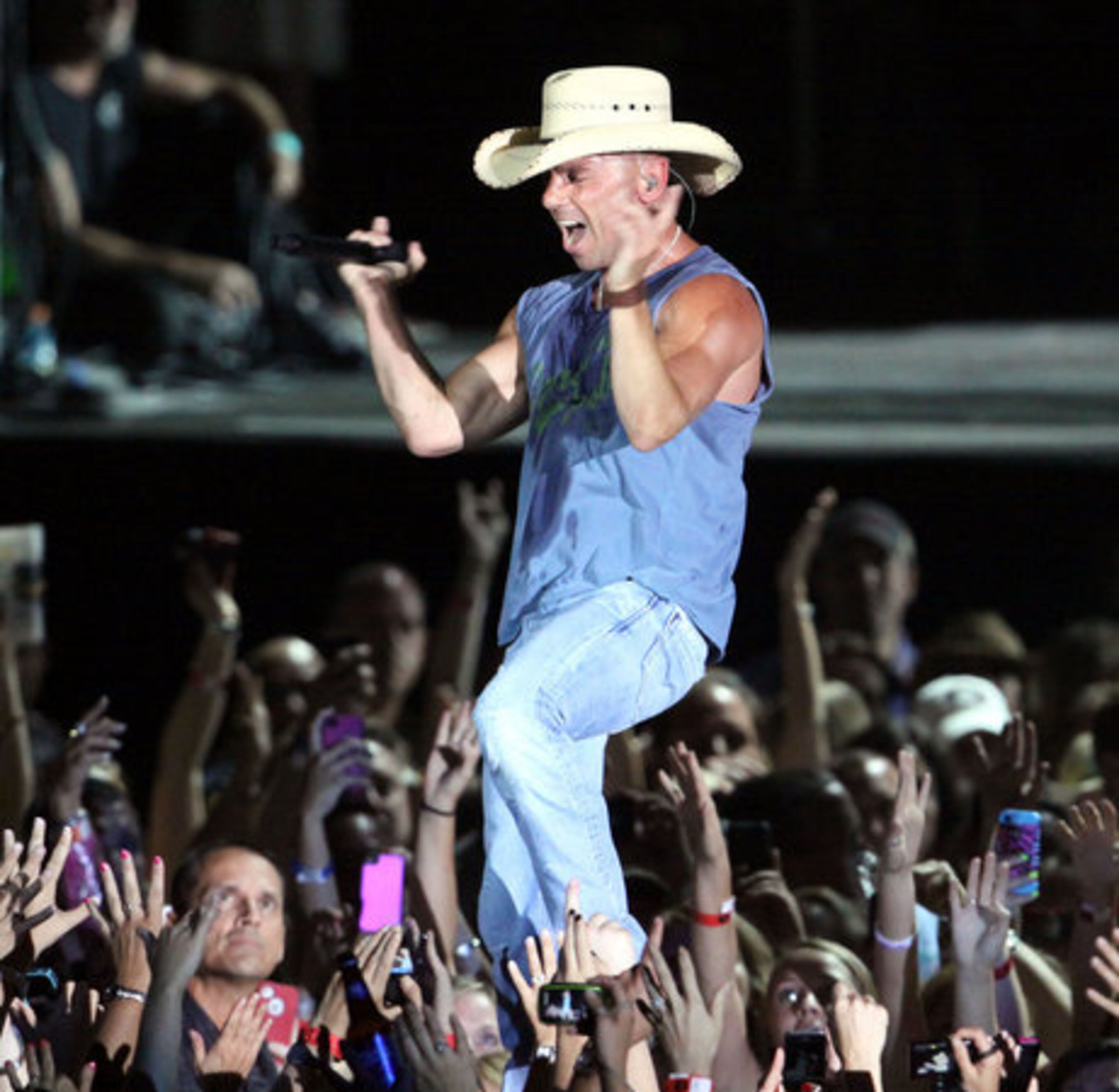 Drenched in sweat a few songs into the set, Kenny Chesney bounced from "Summertime" to "Reality" to the full-throttle rocker "Live Those Songs."