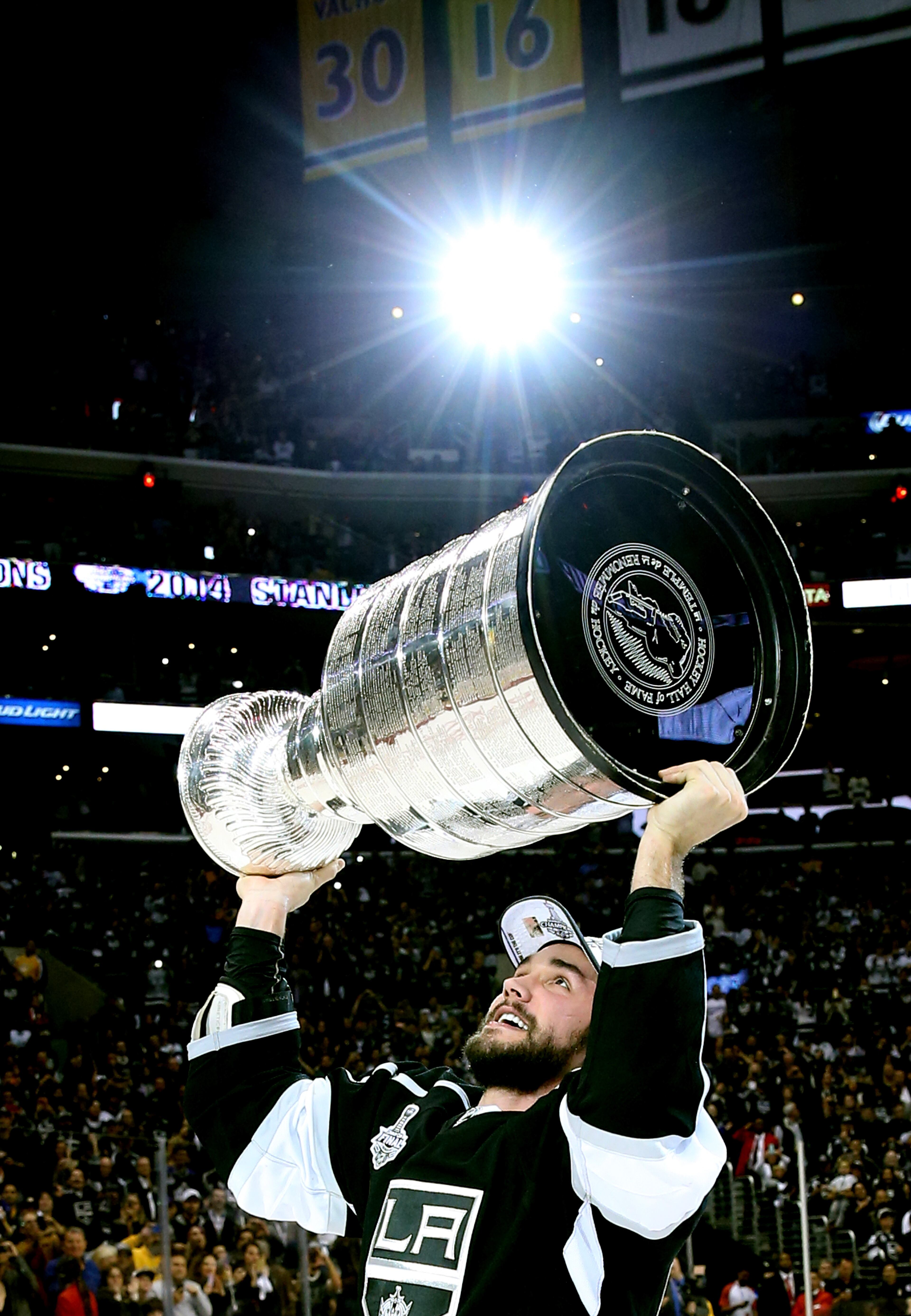 LOS ANGELES, CA - JUNE 13: Alec Martinez #27 of the Los Angeles Kings celebrates with the Stanley Cup after the Kings 3-2 double overtime victory against the New York Rangers in Game Five of the 2014 Stanley Cup Final at Staples Center on June 13, 2014 in Los Angeles, California. (Photo by Bruce Bennett/Getty Images)
