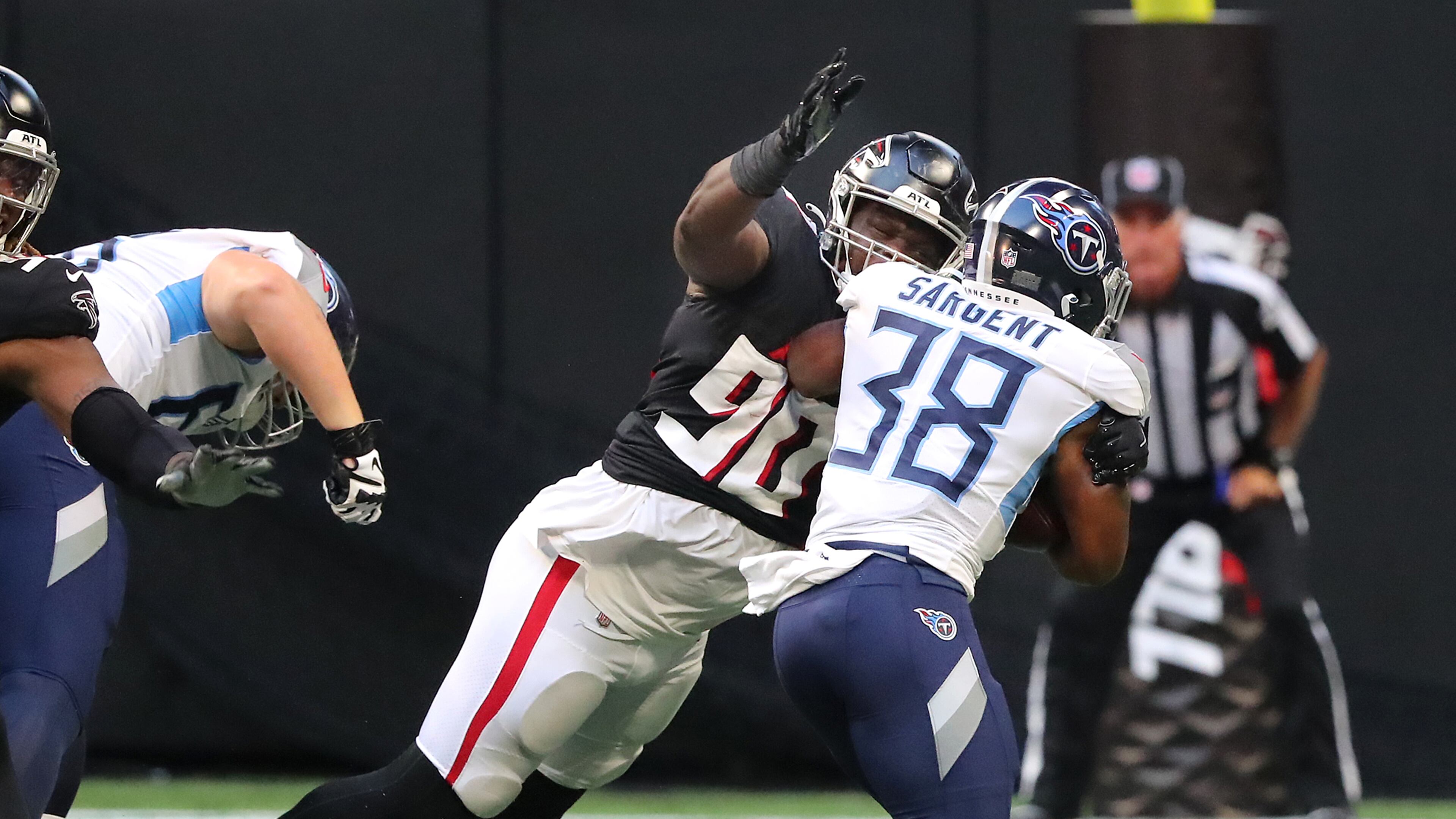 081321 Atlanta: Atlanta Falcons defensive lineman Marlon Davidson tackles Tennessee Titans running back Mekhi Sargent during the first half of a NFL preseason football game on Friday, August 13, 2021, in Atlanta. “Curtis Compton / Curtis.Compton@ajc.com”