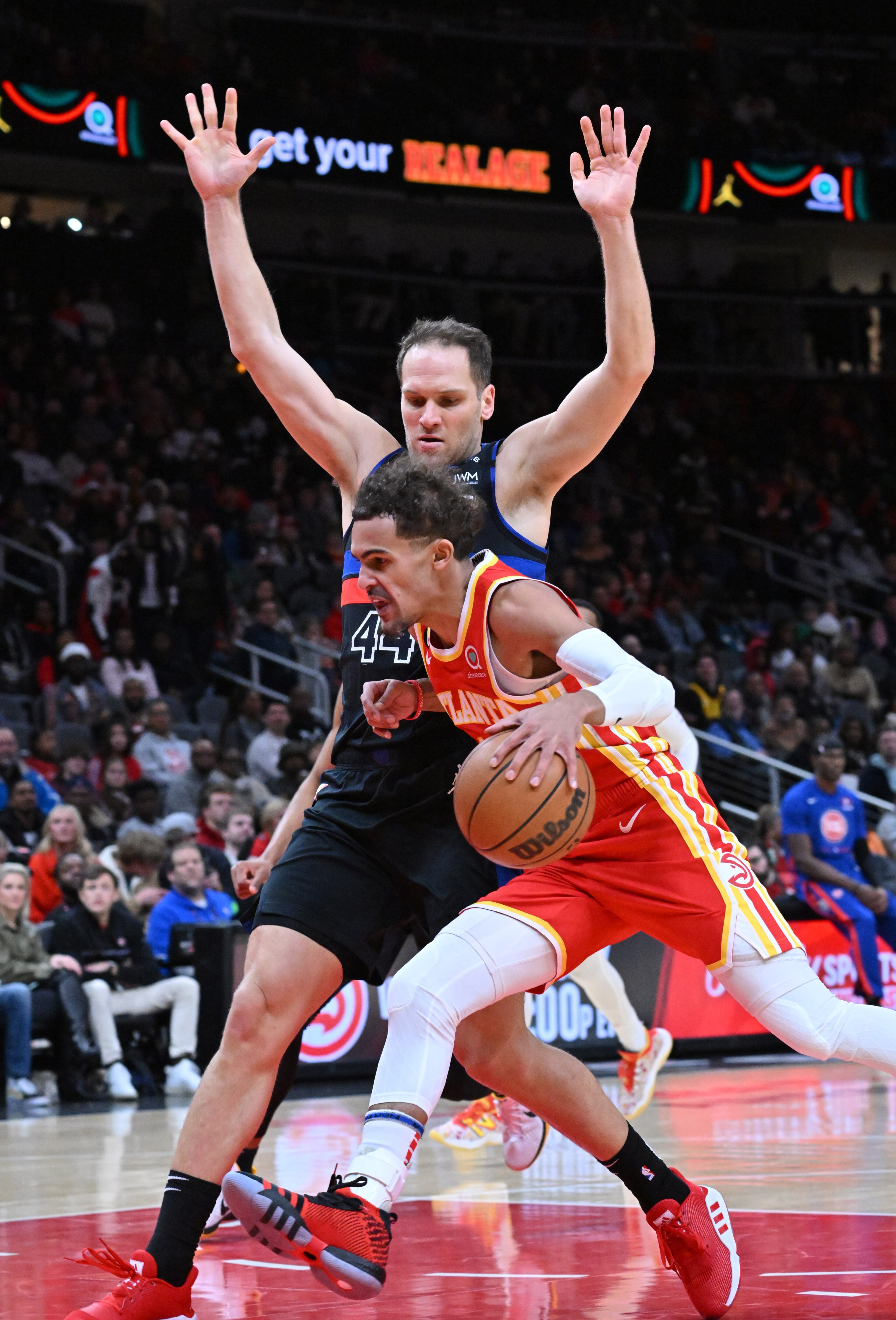 December 23, 2022 Atlanta - Atlanta Hawks' guard Trae Young (11) drives against Detroit Pistons' forward Bojan Bogdanovic (44) during the first half in an NBA basketball game at State Farm Arena on Friday, December 23, 2022. (Hyosub Shin / Hyosub.Shin@ajc.com)