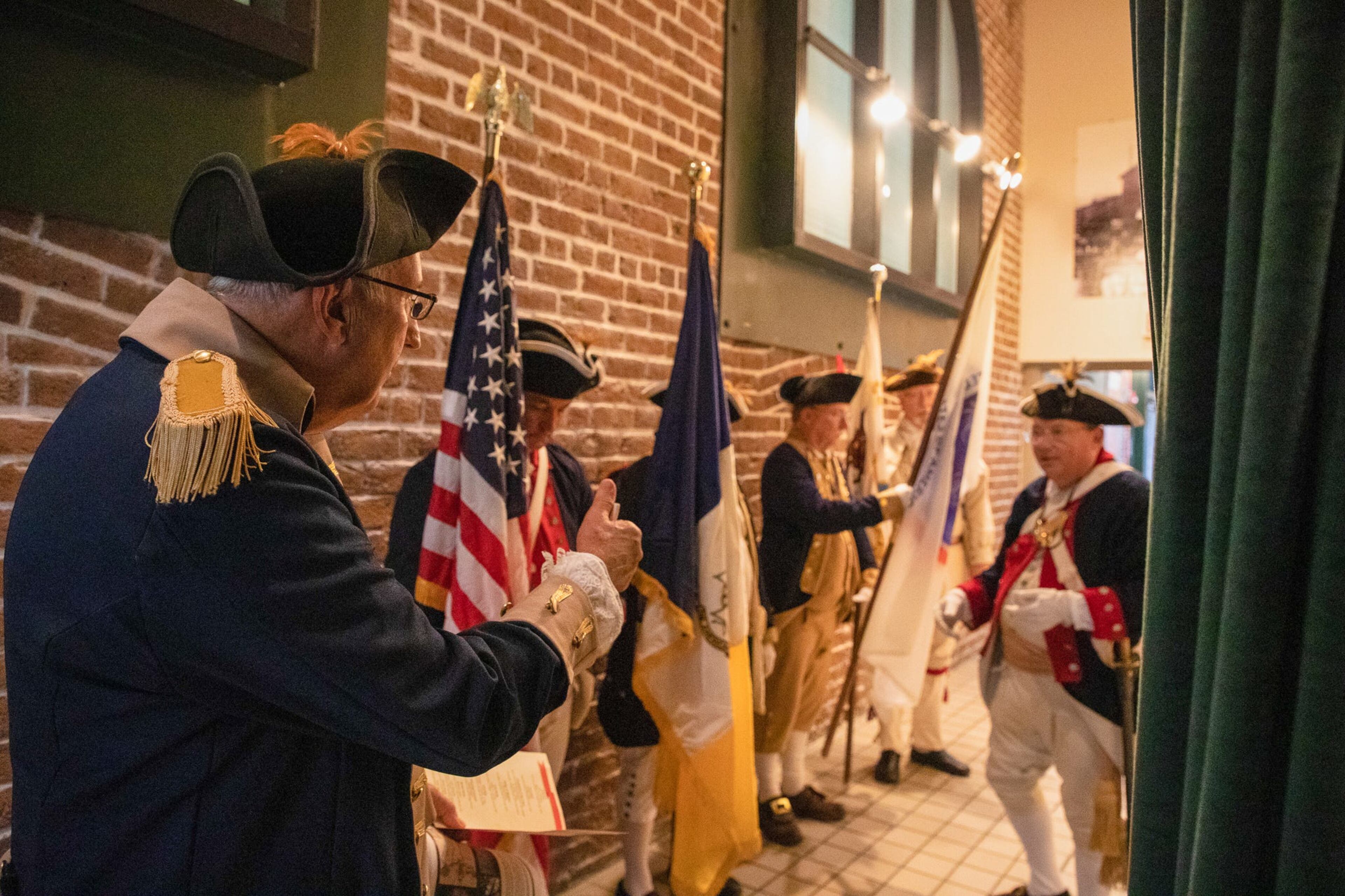The Sons of the American Revolution's Publicist John Trussell oversees the Georgia SAR Color Guard as they prepare to begin the chapter's granite bench dedication ceremony just outside of the Savannah Visitors Center theatre on July 14, 2022. The bench commemorates the American soldiers who fought in the Battle of Savannah on October 9, 1779 and the British withdrawal from Savannah on July 11, 1782.