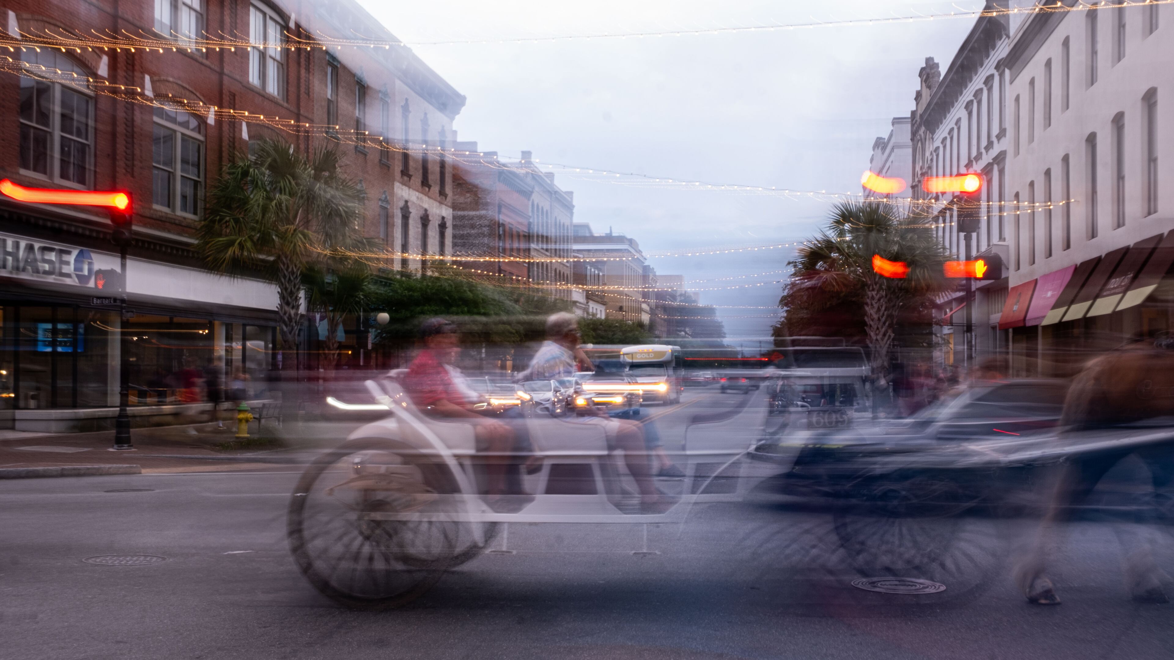 A horse-drawn carriage crosses Broughton Street in downtown Savannah in this 2024 photo. Organizers canceled a Hispanic parade set to take place later this month along Broughton, the city's main retail corridor. (Rosana Lucia for the AJC)