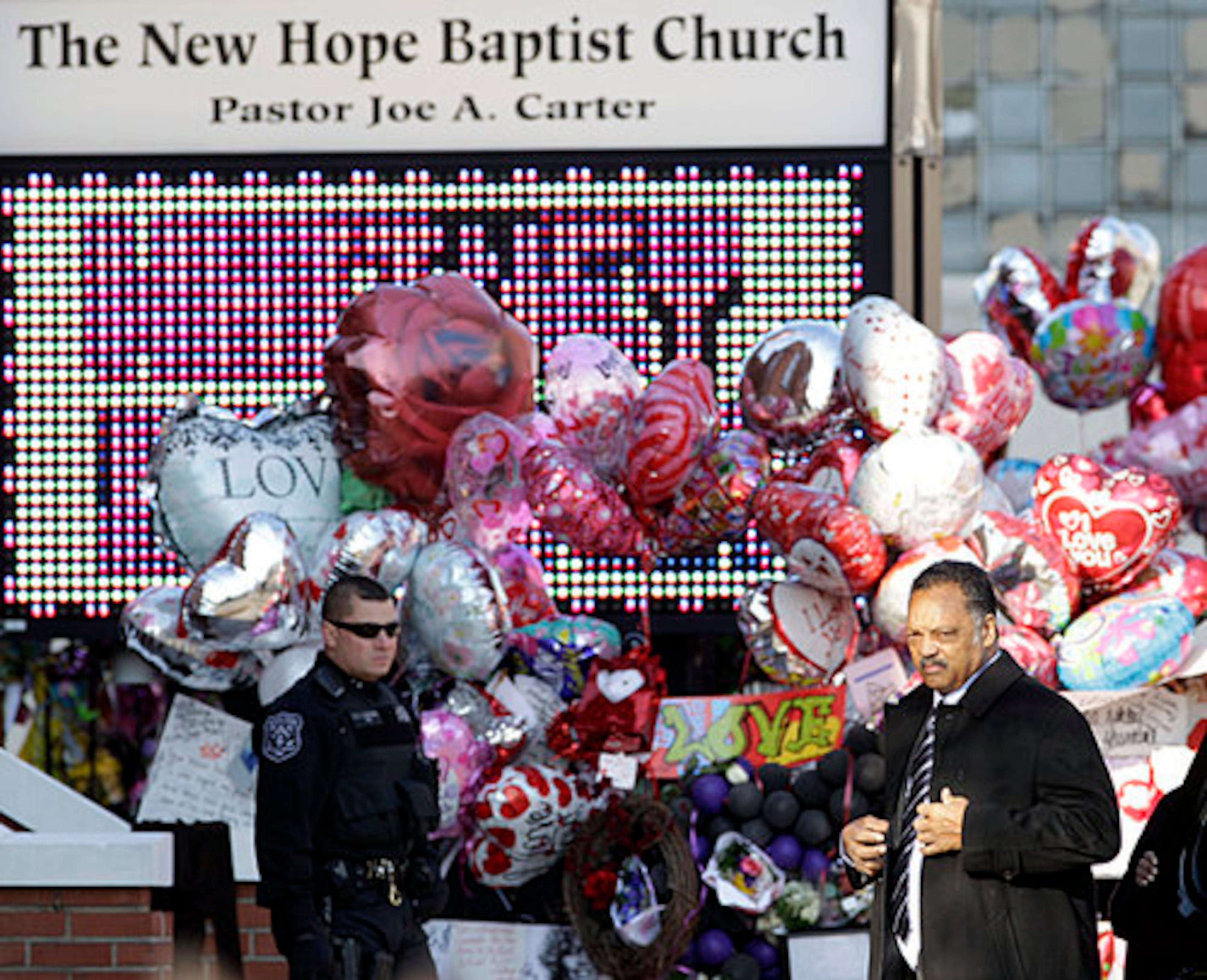 Rev. Jesse Jackson arrives at the New Hope Baptist Church the funeral service.