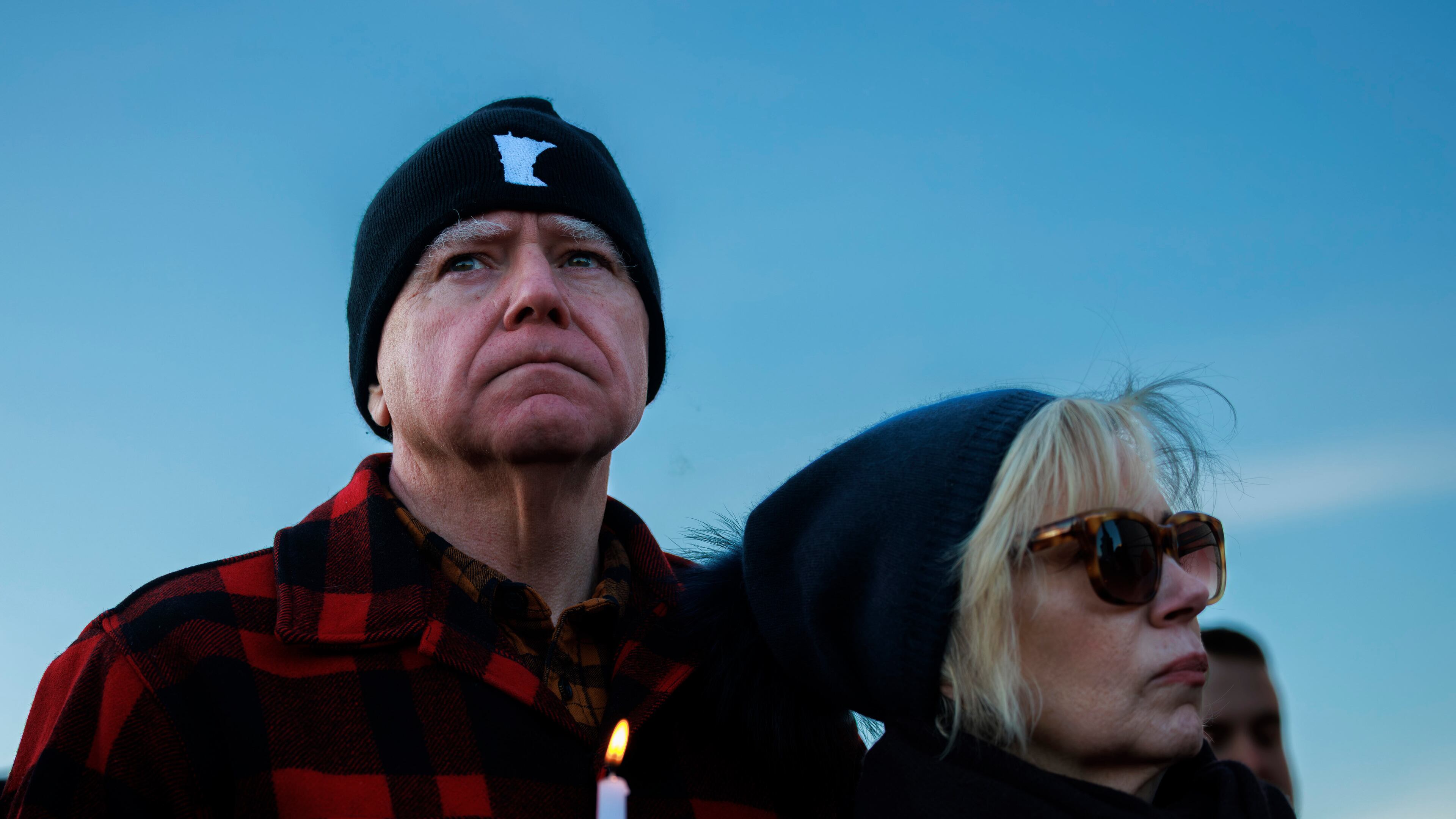 Minnesota Gov. Tim Walz and his wife, Gwen Walz, attend a vigil honoring Renee Good on Friday, Jan. 9, 2026, in St. Paul, Minn., outside the Minnesota State Capitol. (Kerem Yücel/Minnesota Public Radio via AP)