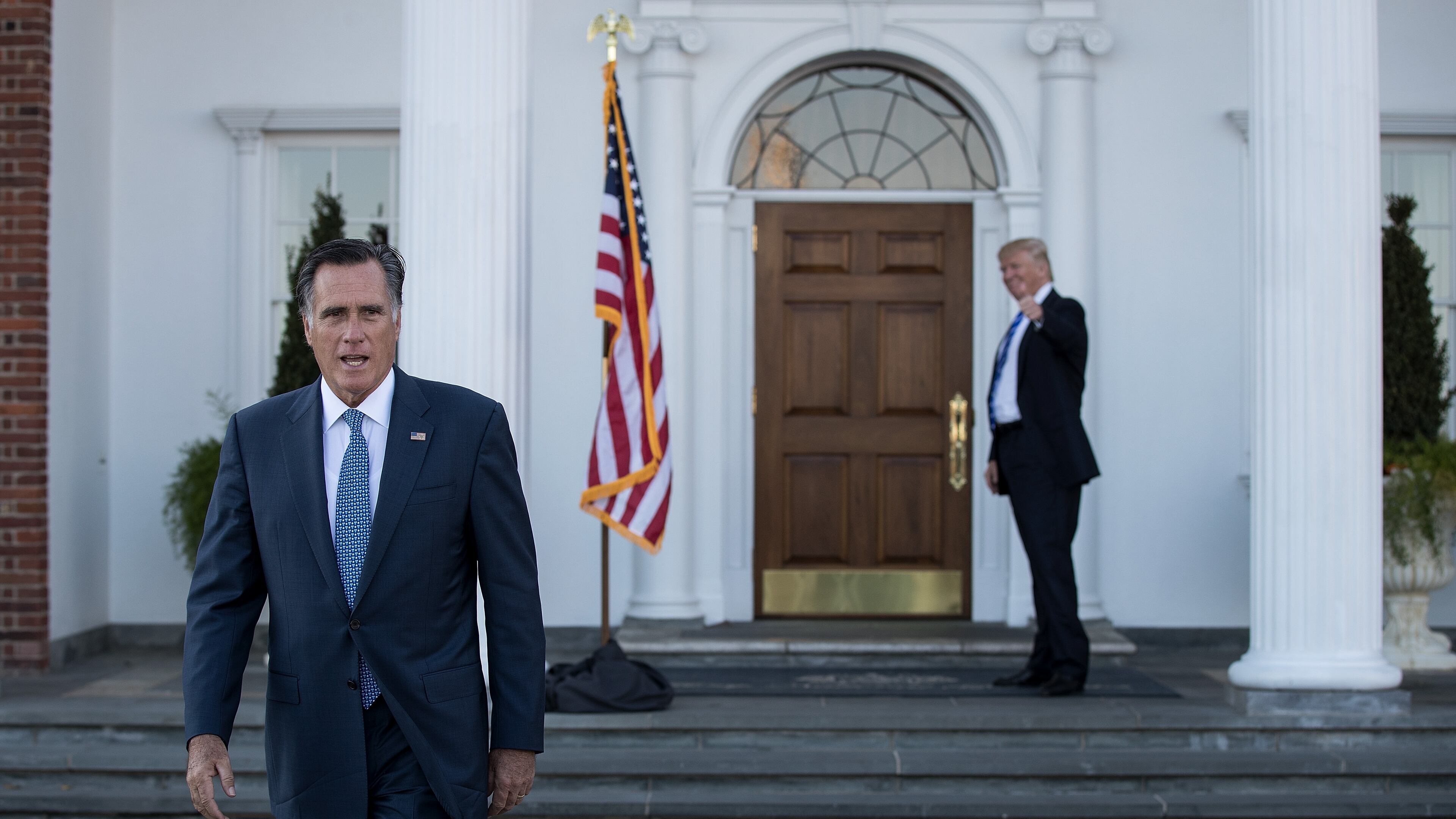 BEDMINSTER TOWNSHIP, NJ - NOVEMBER 19: (L to R) Mitt Romney walks to speak to the press as President-elect Donald Trump gives the thumbs up after their meeting at Trump International Golf Club, November 19, 2016 in Bedminster Township, New Jersey. Trump and his transition team are in the process of filling cabinet and other high level positions for the new administration. (Photo by Drew Angerer/Getty Images) *** BESTPIX ***