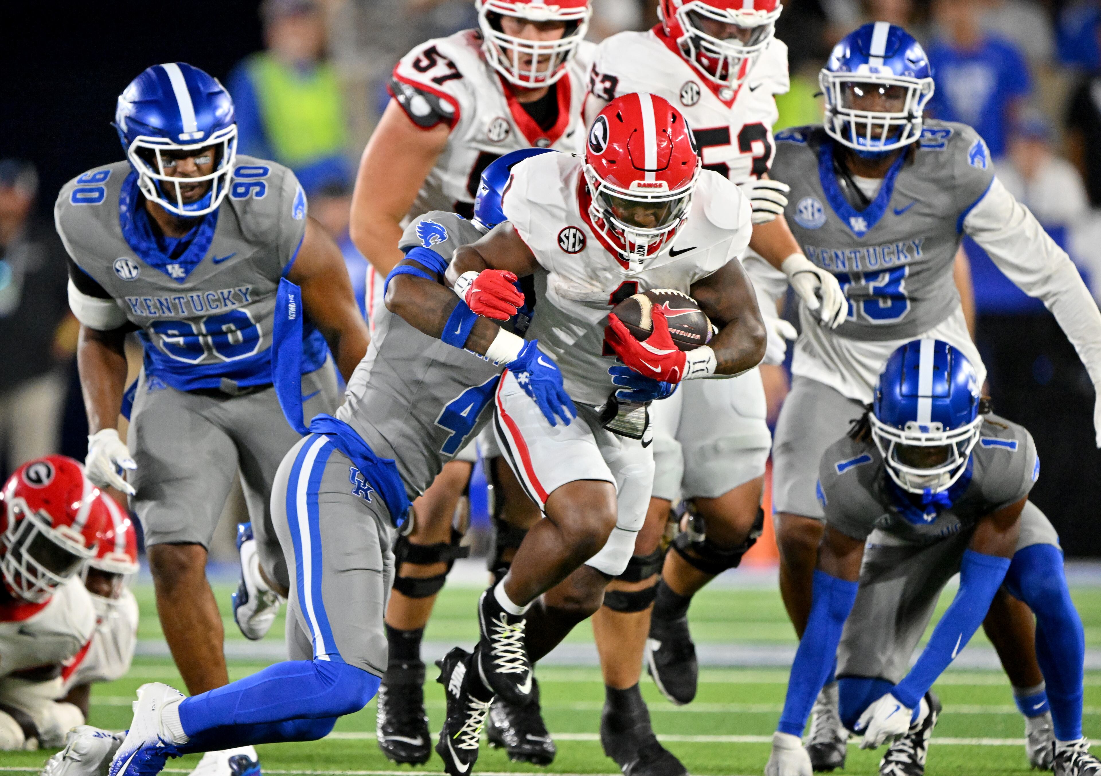 Georgia running back Trevor Etienne (1) gets tackled by Kentucky defensive back Kristian Story (4) during the second half in an NCAA football game at Kroger Field, Saturday, September 14, 2024, in Lexington, Kentucky. Georgia won 13-12 over Kentucky. (Hyosub Shin / AJC)