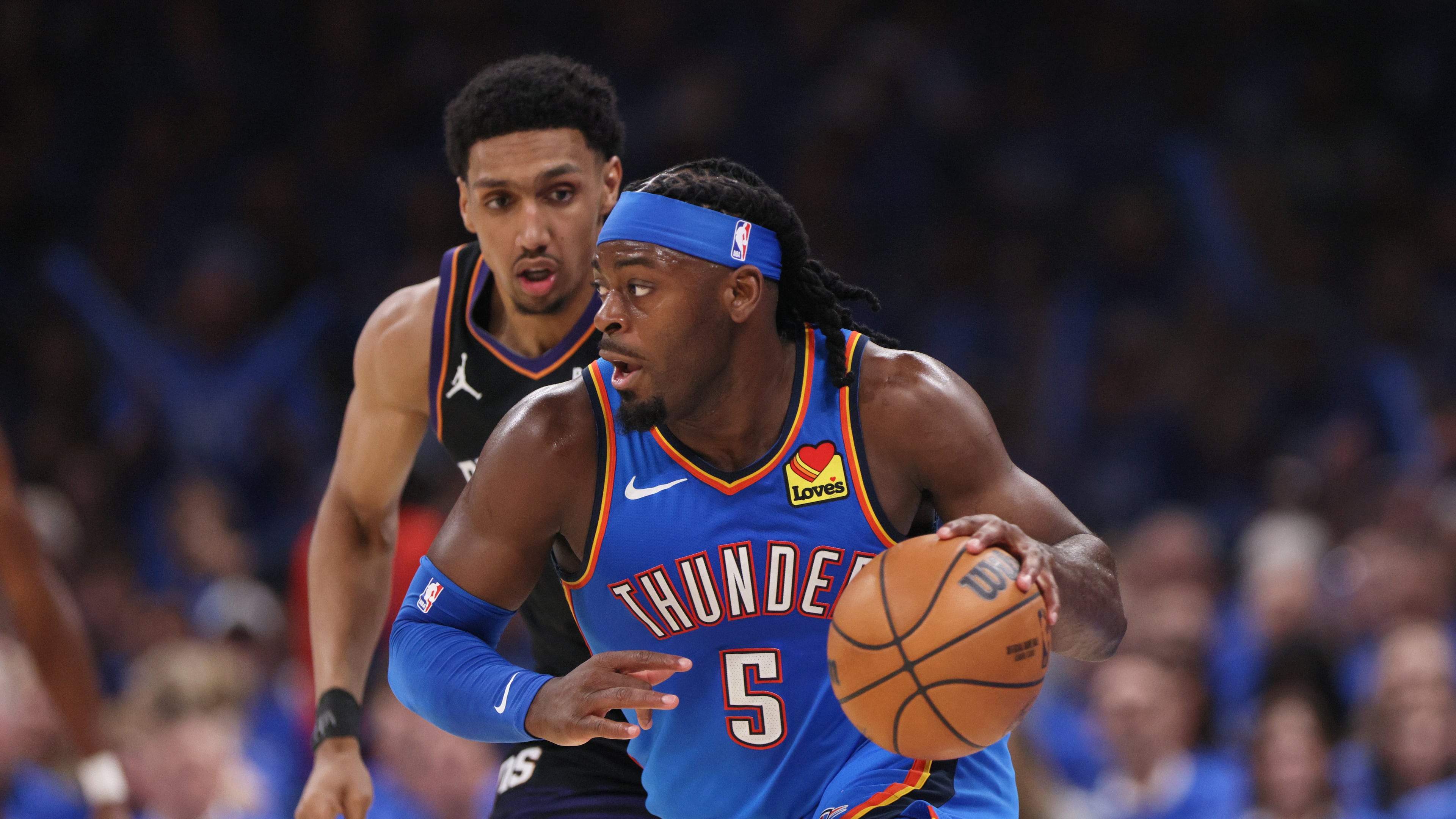 Oklahoma City Thunder guard Luguentz Dort leads a fast break in front of Phoenix Suns forward Ryan Dunn during the second half in Game 1 of a first-round NBA playoffs basketball series Sunday, April 19, 2026, in Oklahoma City. (Nate Billings/AP)