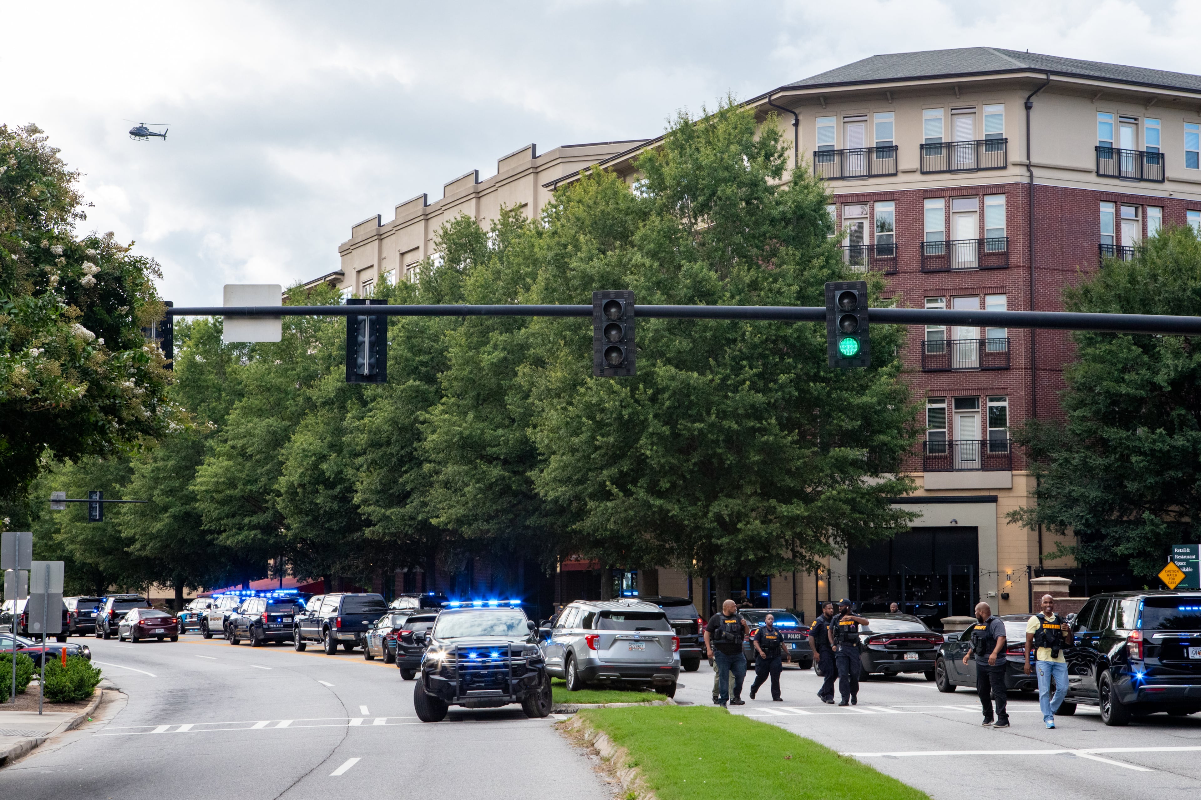 Law enforcement responds to an active shooter on Clifton Road near the CDC main entrance and Emory Point, which has housing for many Emory University students, shopping, restaurants a CVS and day care center, on Friday, Aug 8, 2025. (Jenni Girtman for the Atlanta Journal-Constitution)