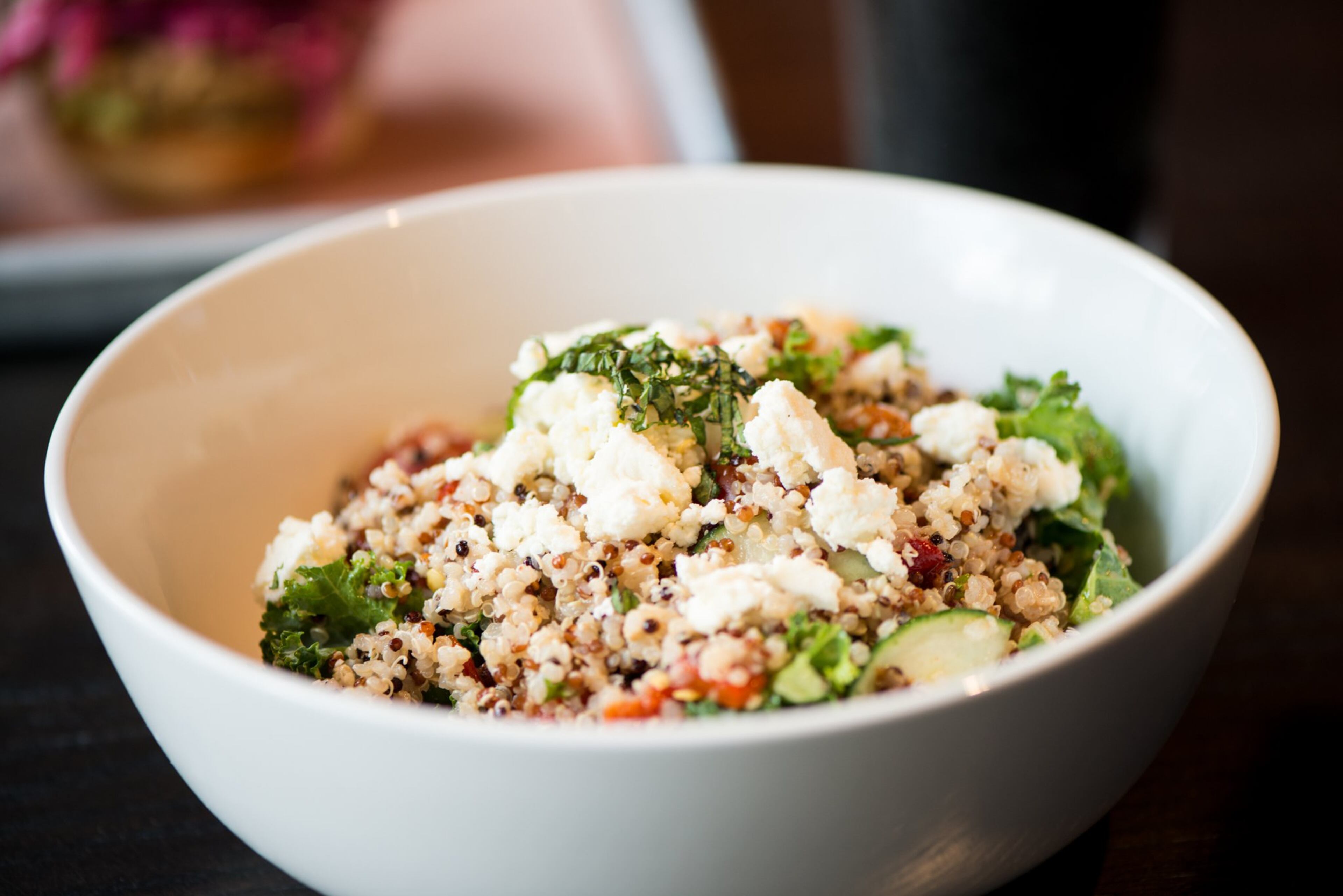 Garden Bowl with quinoa, kale, cucumbers, cherry tomatoes, roasted red peppers and cauliflower topped with fresh mint, feta cheese, and lemon vinaigrette. Photo credit- Mia Yakel.