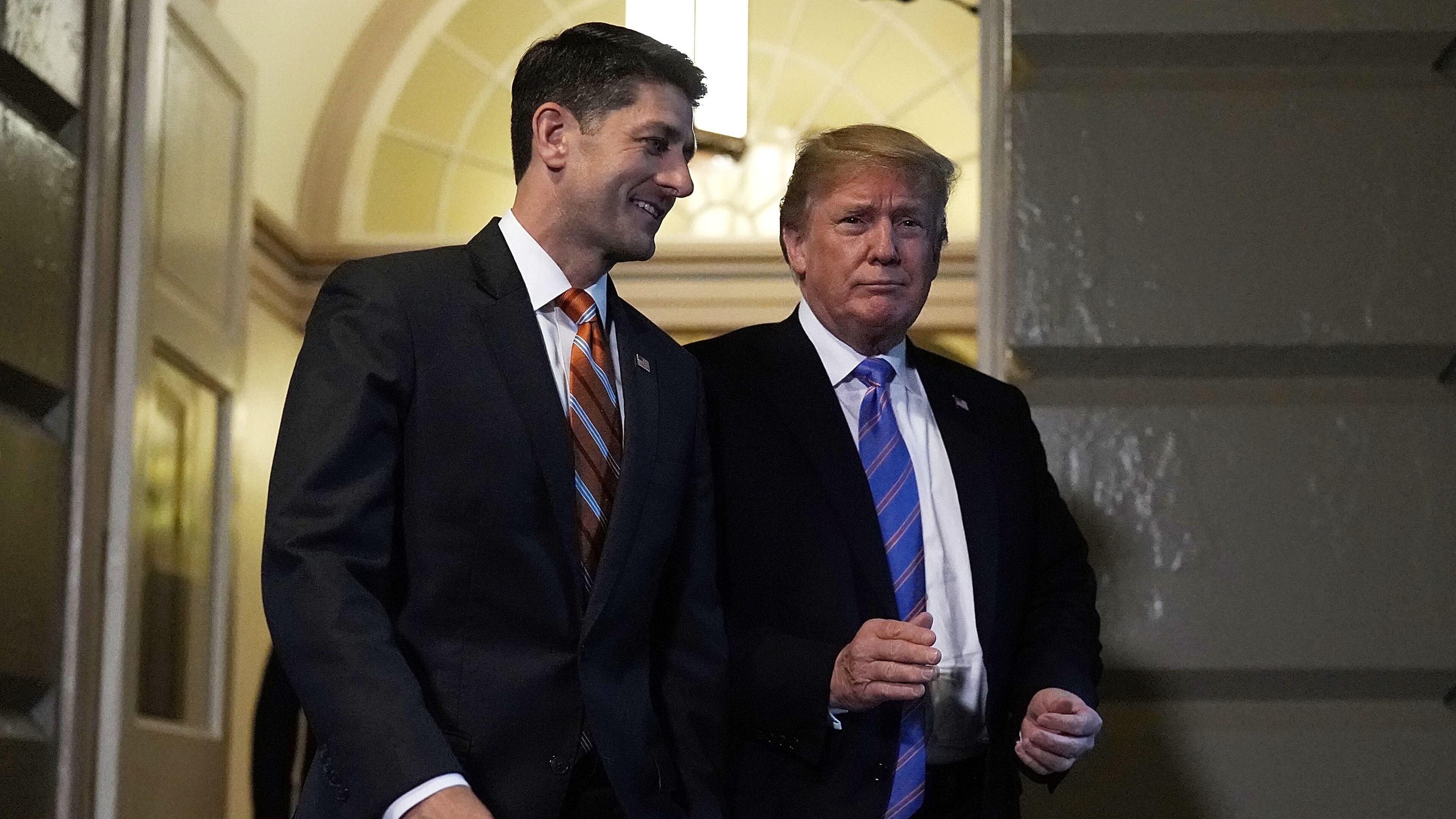 Accompanied by Speaker Paul Ryan, R-Wisc., President Donald Trump arrives at a meeting with House Republicans at the U.S. Capitol on Tuesday. Alex Wong/Getty Images