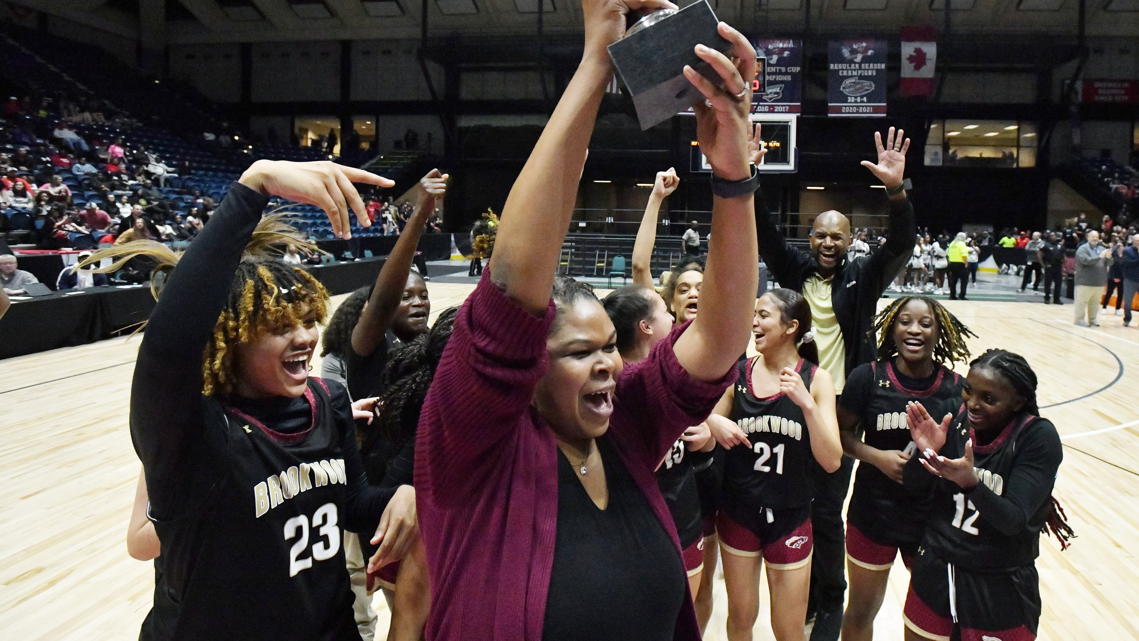 Brookwood's head coach Courtney Mincy holds up the championship trophy during 2023 GHSA Basketball Class 7A Girl’s State Championship game at the Macon Centreplex, Saturday, March 11, 2023, in Macon, GA. (Hyosub Shin / Hyosub.Shin@ajc.com)