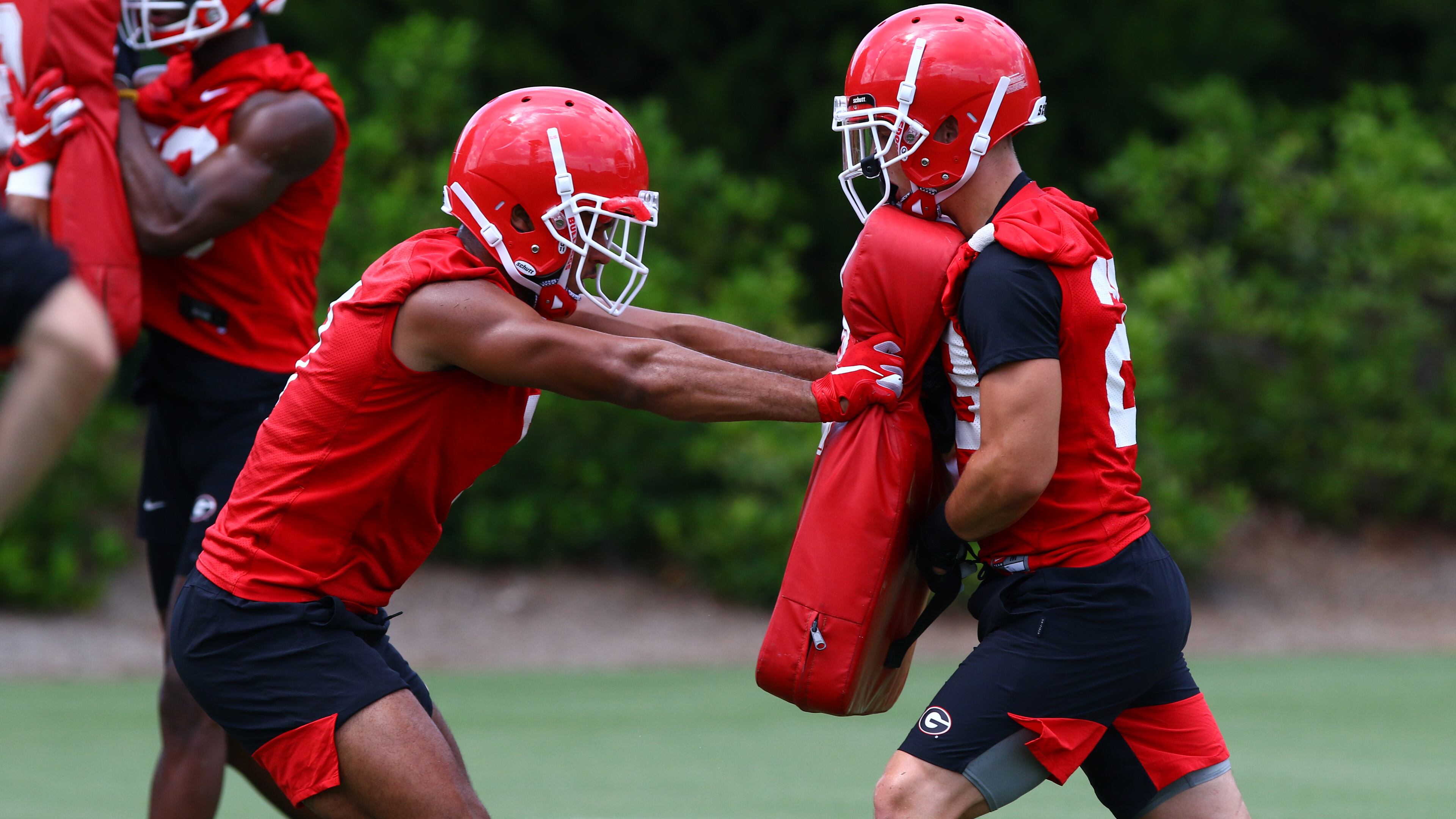 Georgia receiver Dominic Blaylock (left) blogs during the Bulldogs' practice Saturday, Aug. 3, 2019, on Woodruff Practice Field in Athens.