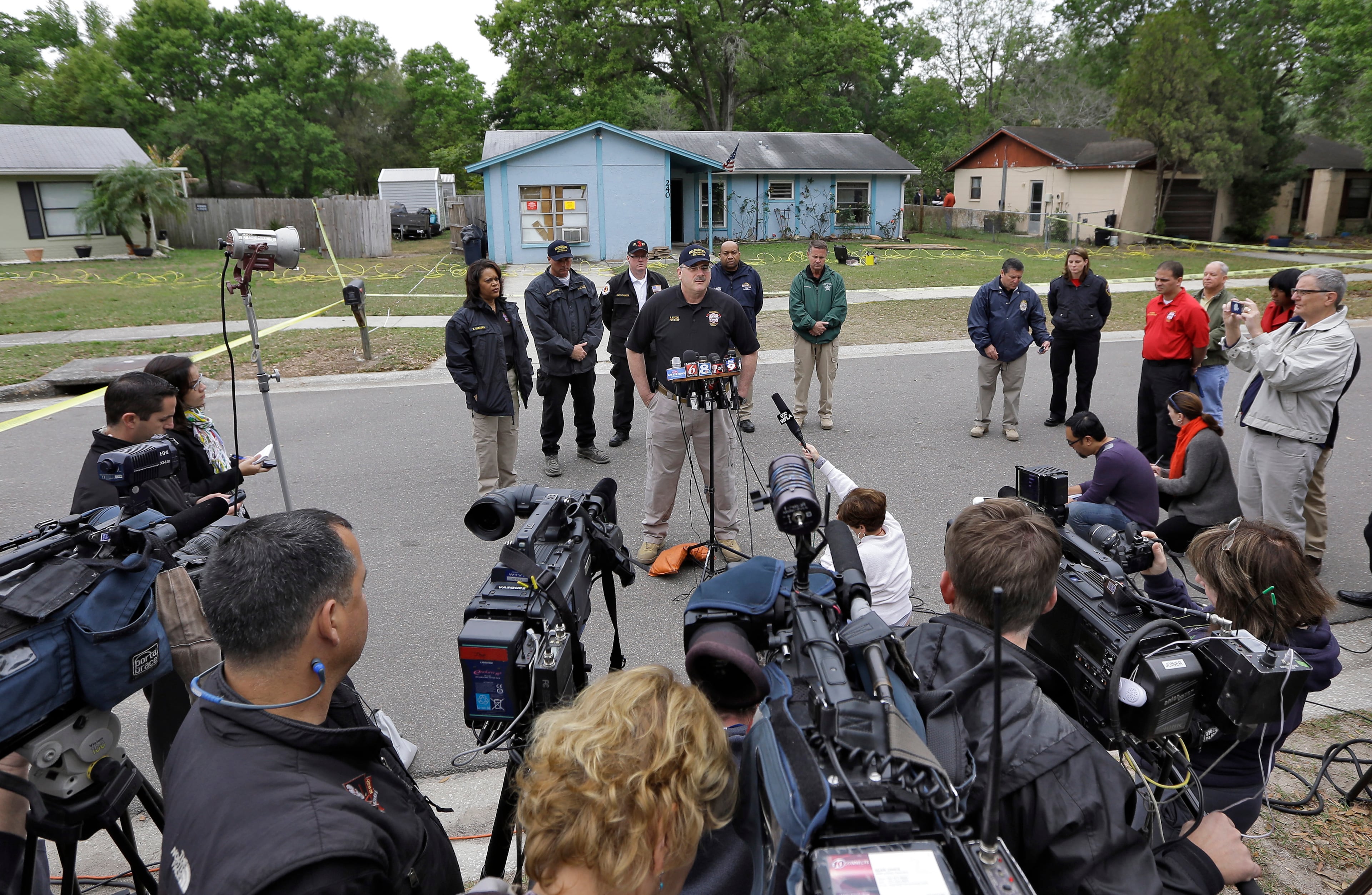 Hillsborough County Fire Chief Ron Rogers speaks to the media in front of the home where the sinkhole opened up.