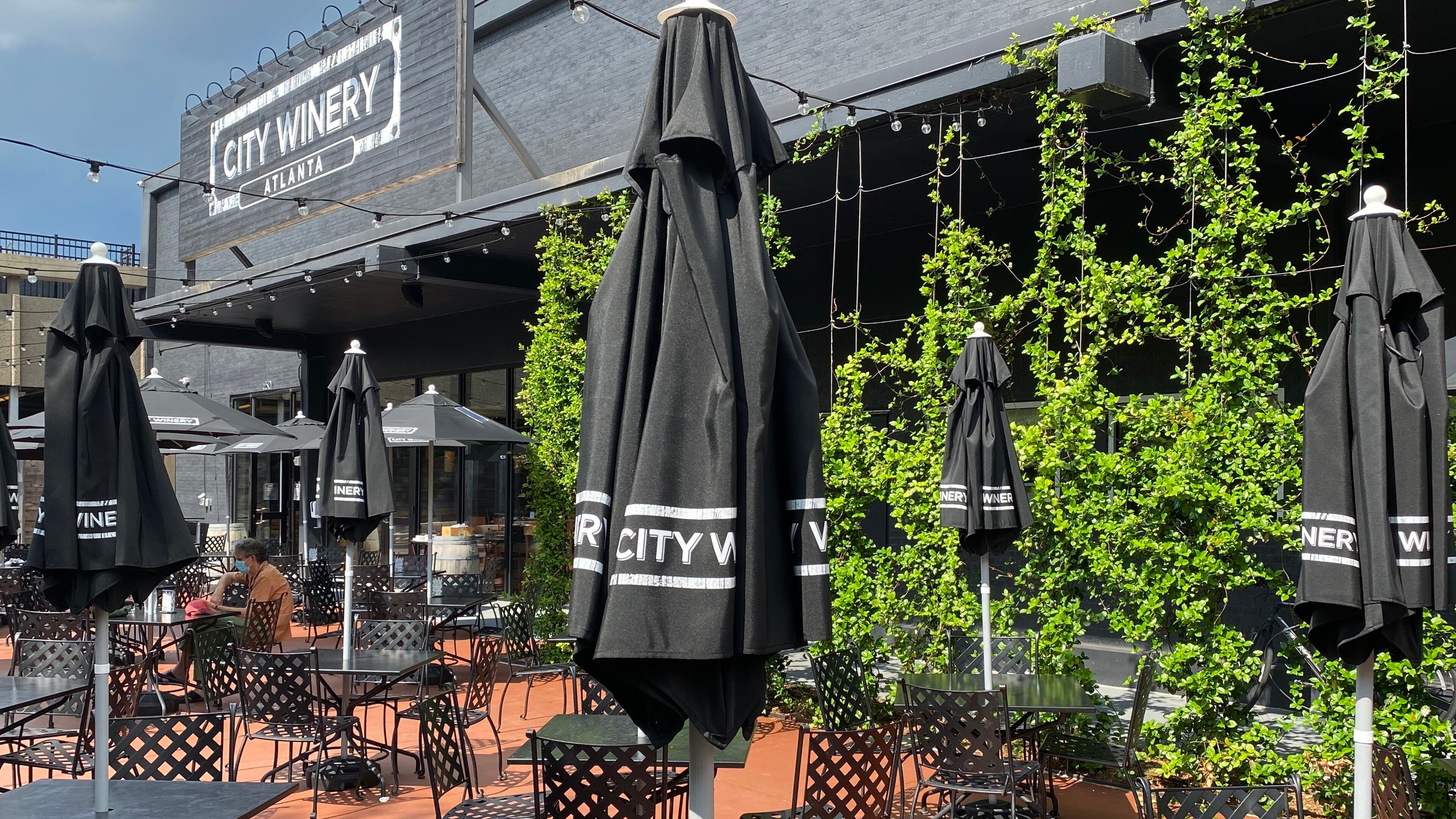 The May reopening of City Winery brought a revamped design with plenty of outdoor upgrades that include umbrella tables and plush lounge seating around a fire pit. (Ligaya Figueras / ligaya.figueras@ajc.com)