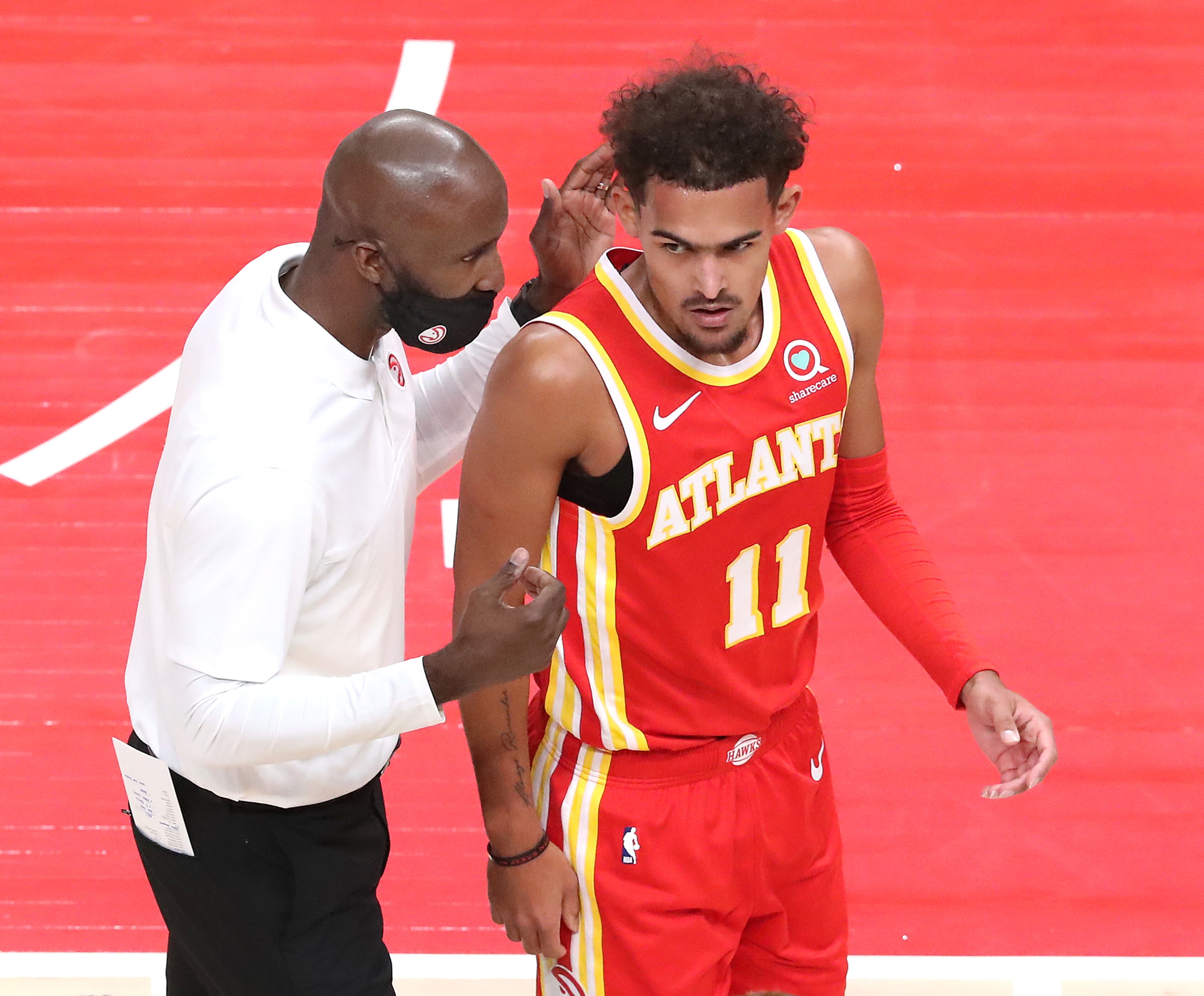 Hawks head coach Lloyd Pierce confers with Trae Young during 1st half action against the Detroit Pistons in a NBA basketball game on Monday, Dec. 28, 2020, in Atlanta. “Curtis Compton / Curtis.Compton@ajc.com”