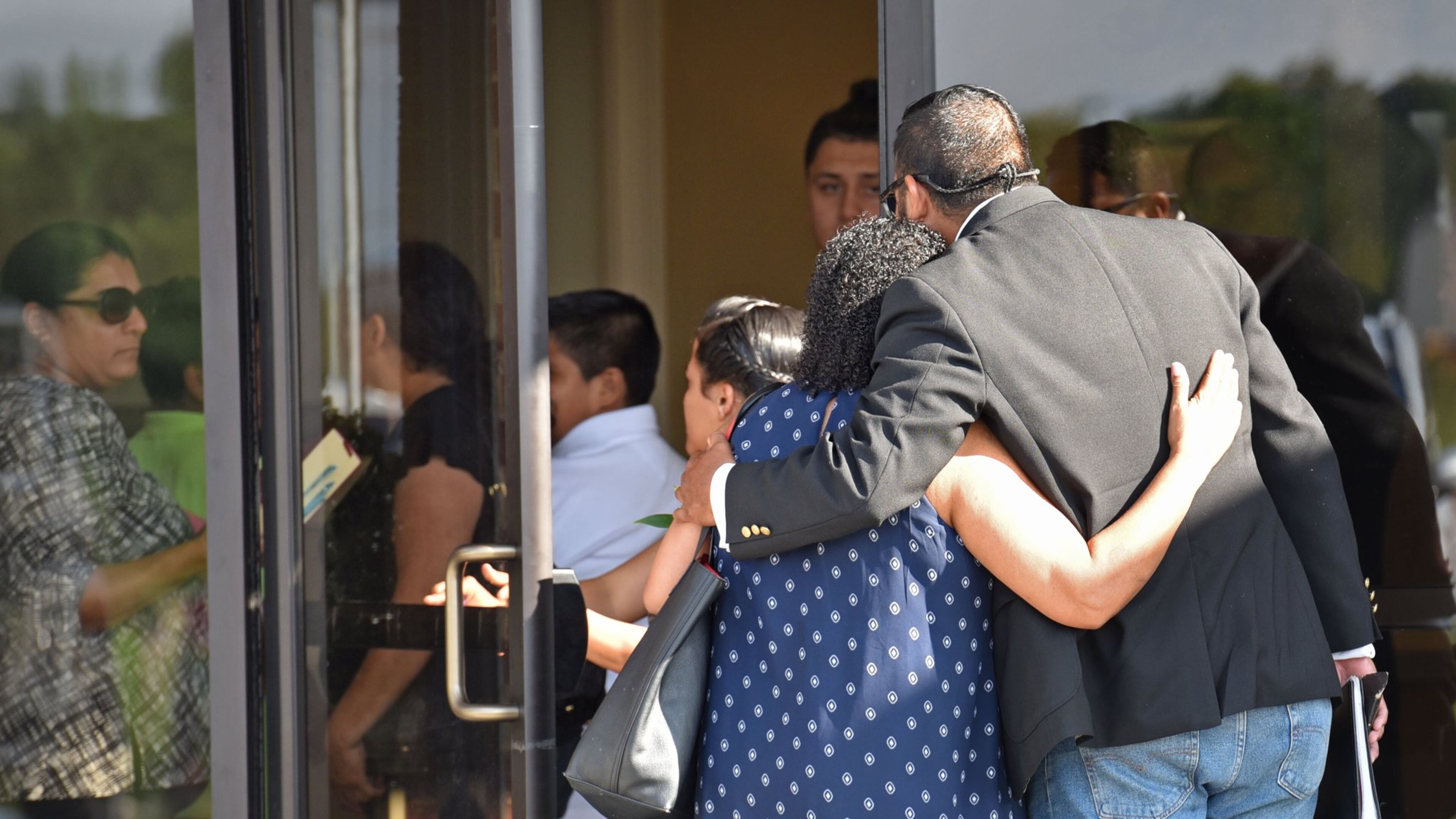 July 12, 2017 Lawrenceville - Mourners embrace arriving for the visitation for the victims - Martin Romero, 33, and four siblings, including 1-year-old Axel, 4-year-old Dillan, 7-year-old Dacota and 10-year-old Isabela Martinez - at Byrd and Flanigan Crematory & Funeral Service in Lawrenceville. on Wednesday, July 12, 2017. HYOSUB SHIN / HSHIN@AJC.COM
