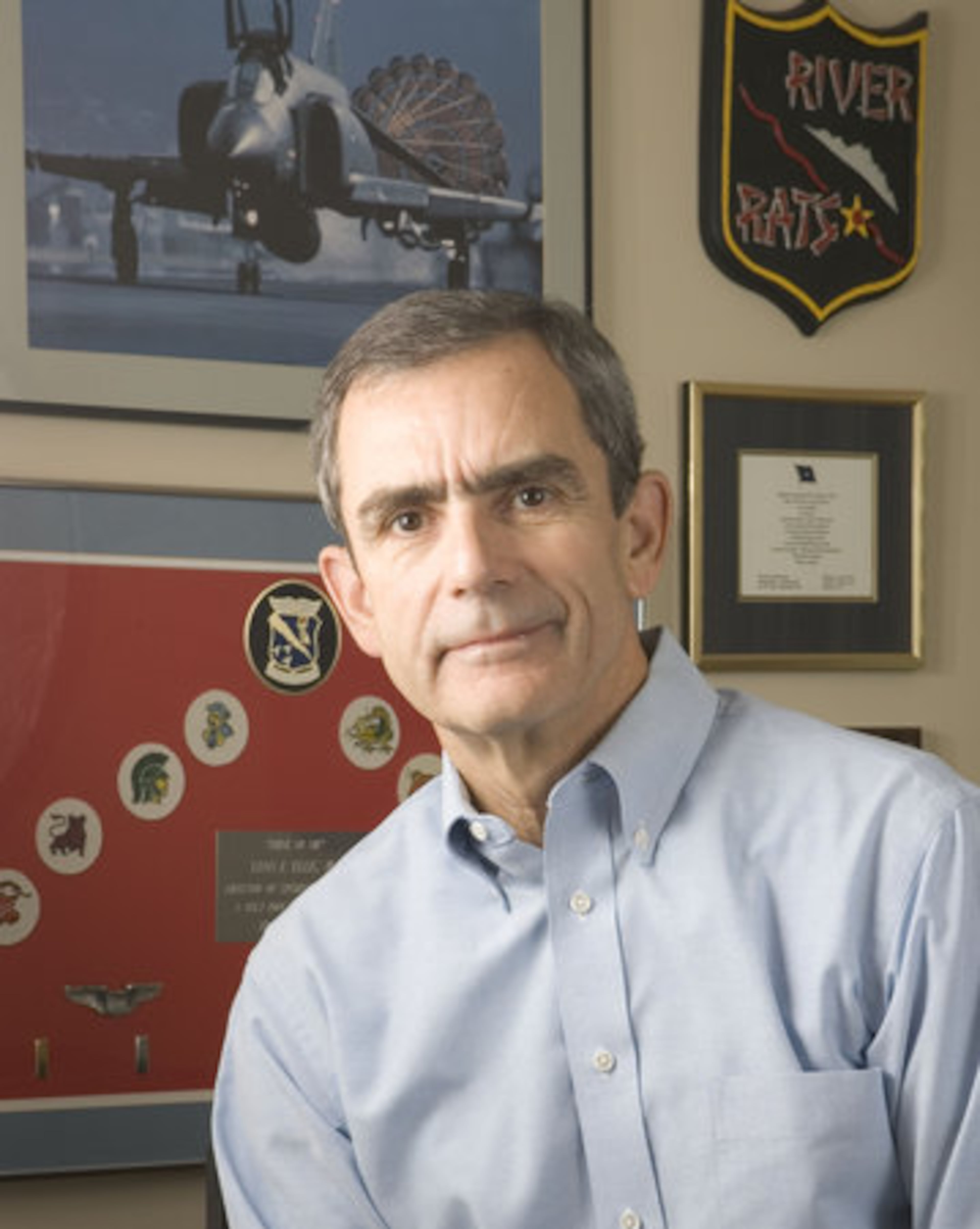 Lee Ellis, an Air Force pilot during the Vietnam War, was shot down a few days before John McCain and was dragged into the same Hanoi prison. Both men spent five years there. Ellis retired from the Air Force as a colonel and lives in Cumming. Behind Ellis is a photograph of the F4, the type of plane he flew.