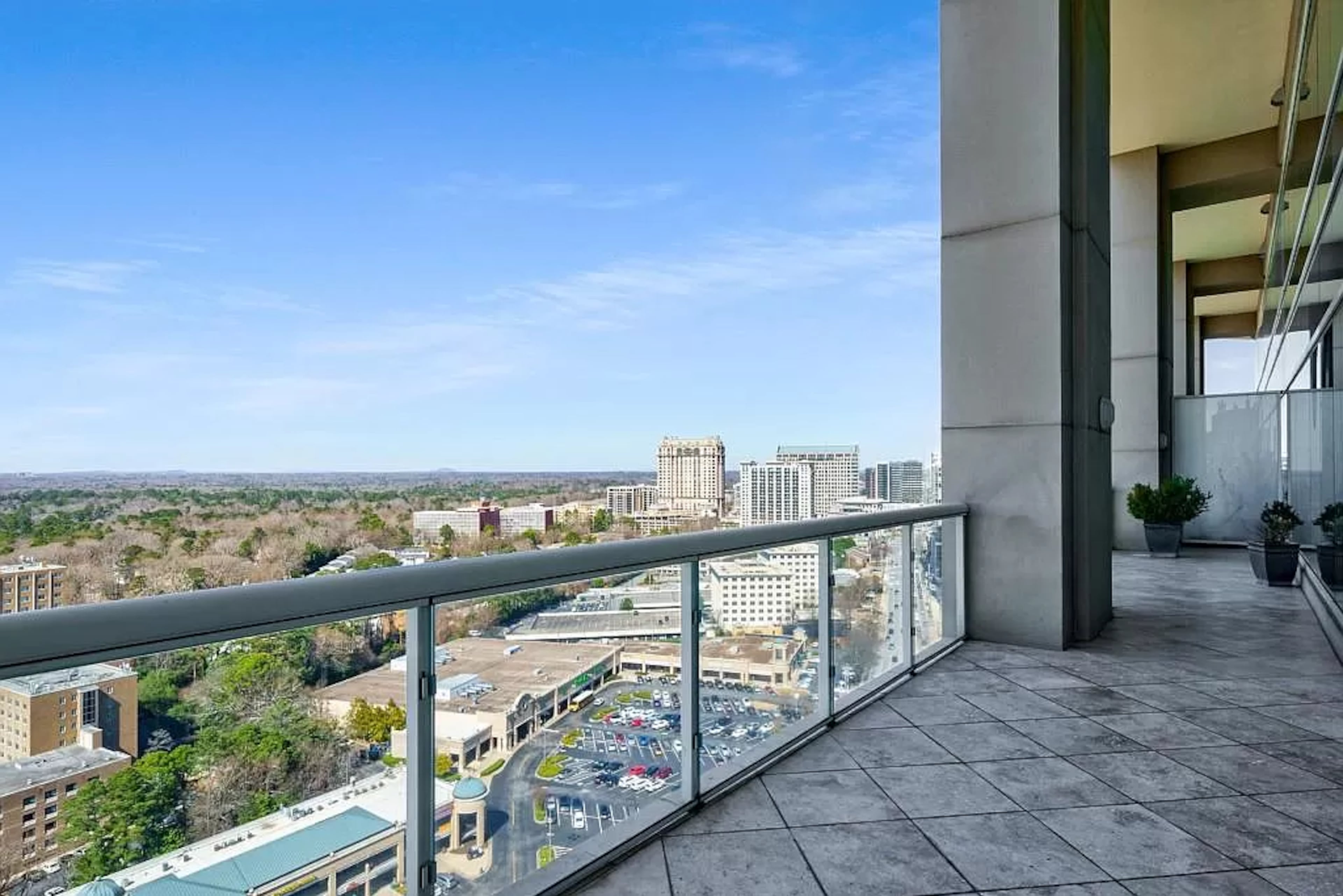 Floor-to-ceiling windows and sliding glass doors open out onto this covered terrace creating additional living space.