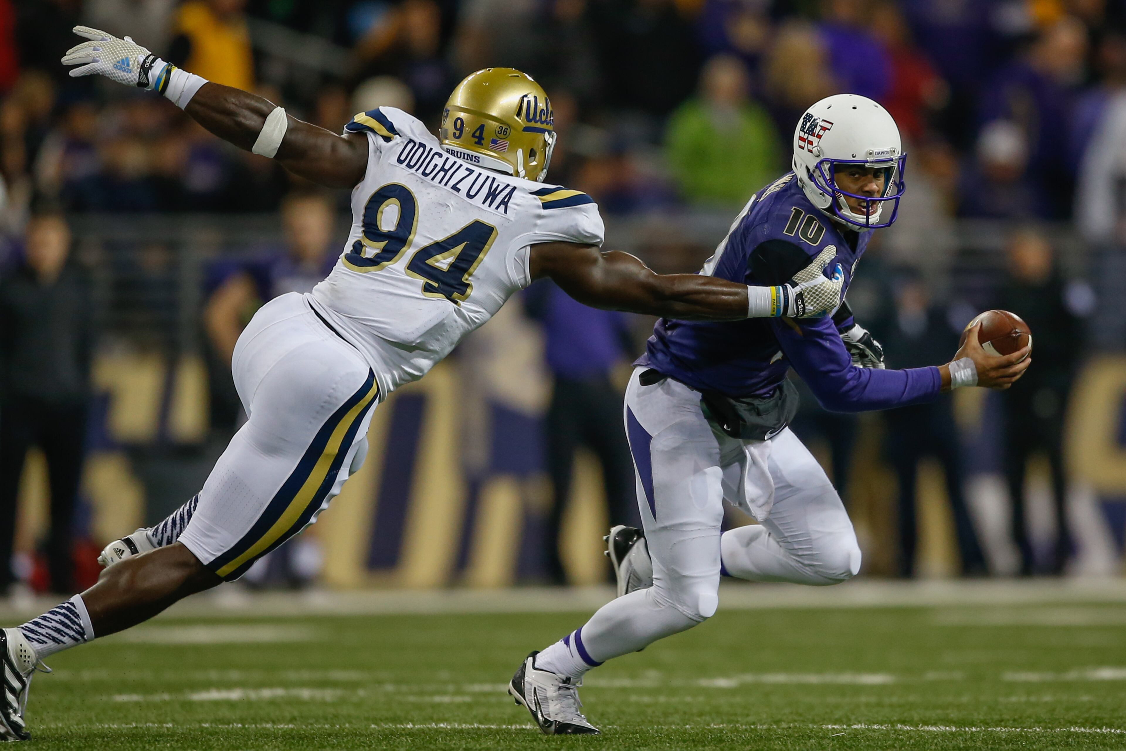 Owamagbe Odighizuwa of UCLA has Washington quarterback Cyler Miles in his sights last November. (Photo by Otto Greule Jr/Getty Images)