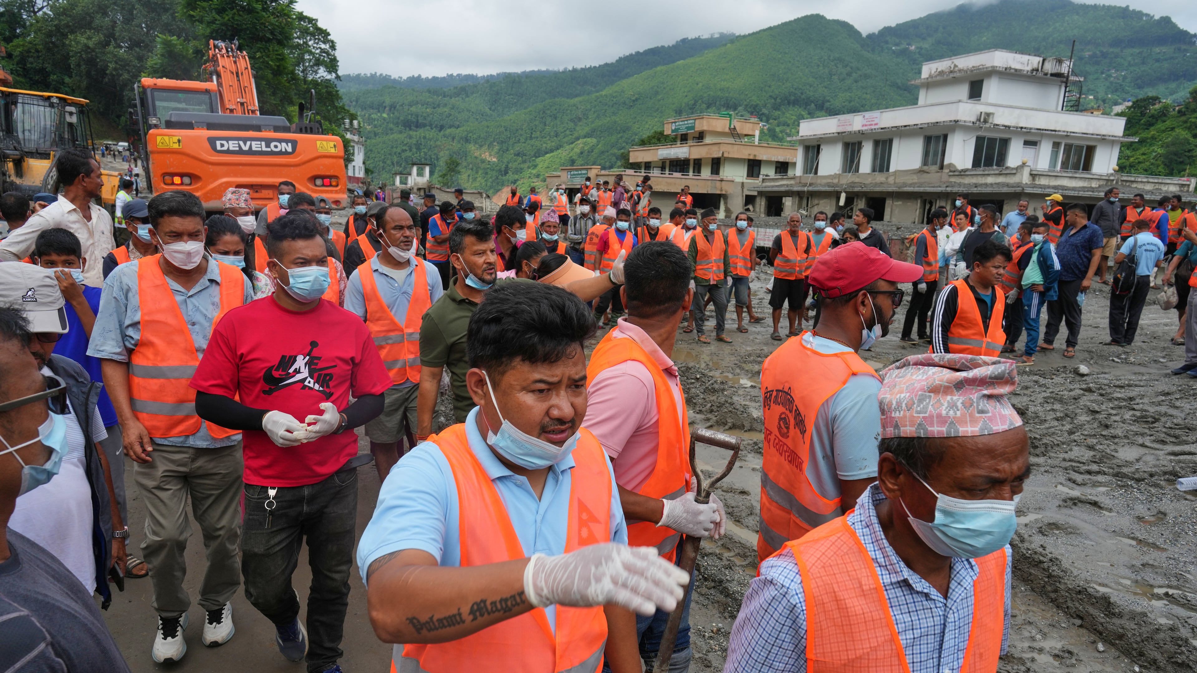 Rescuers arrive at a village affected by flash flooding in Nepal's Nuwakot district, Monday, Aug. 31, 2026. (AP Photo/Rajesh Kumar Singh)