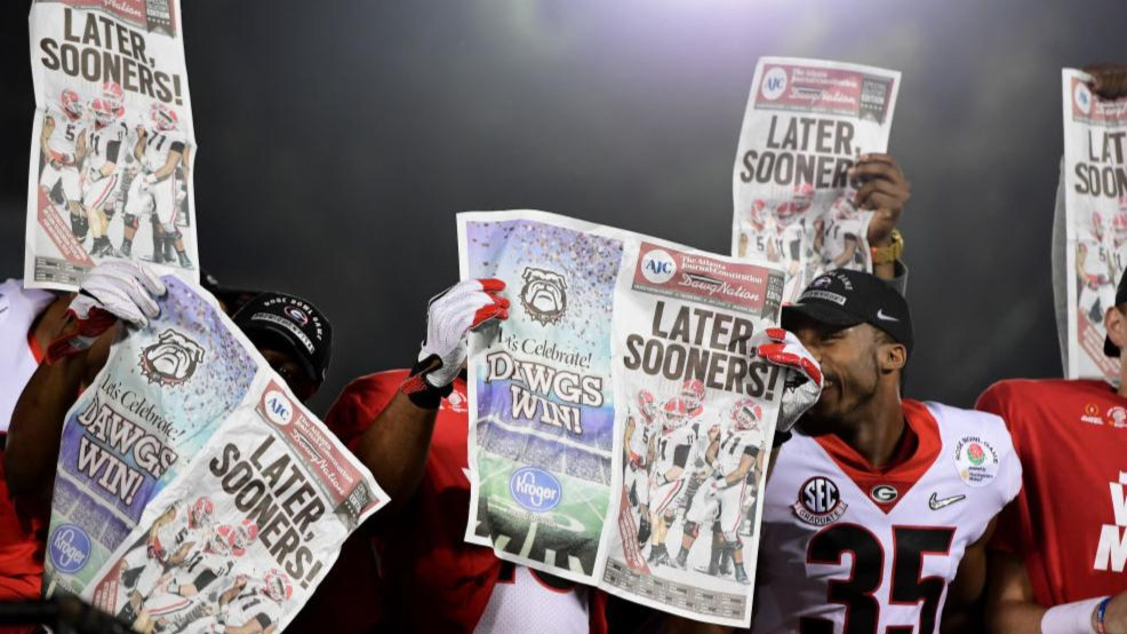 The Georgia Bulldogs celebrate with newspapers after the Bulldogs beat the Oklahoma Sooners 54-48 in double overtime in the 2018 College Football Playoff Semifinal Game at the Rose Bowl Game presented by Northwestern Mutual at the Rose Bowl on January 1, 2018 in Pasadena, California.